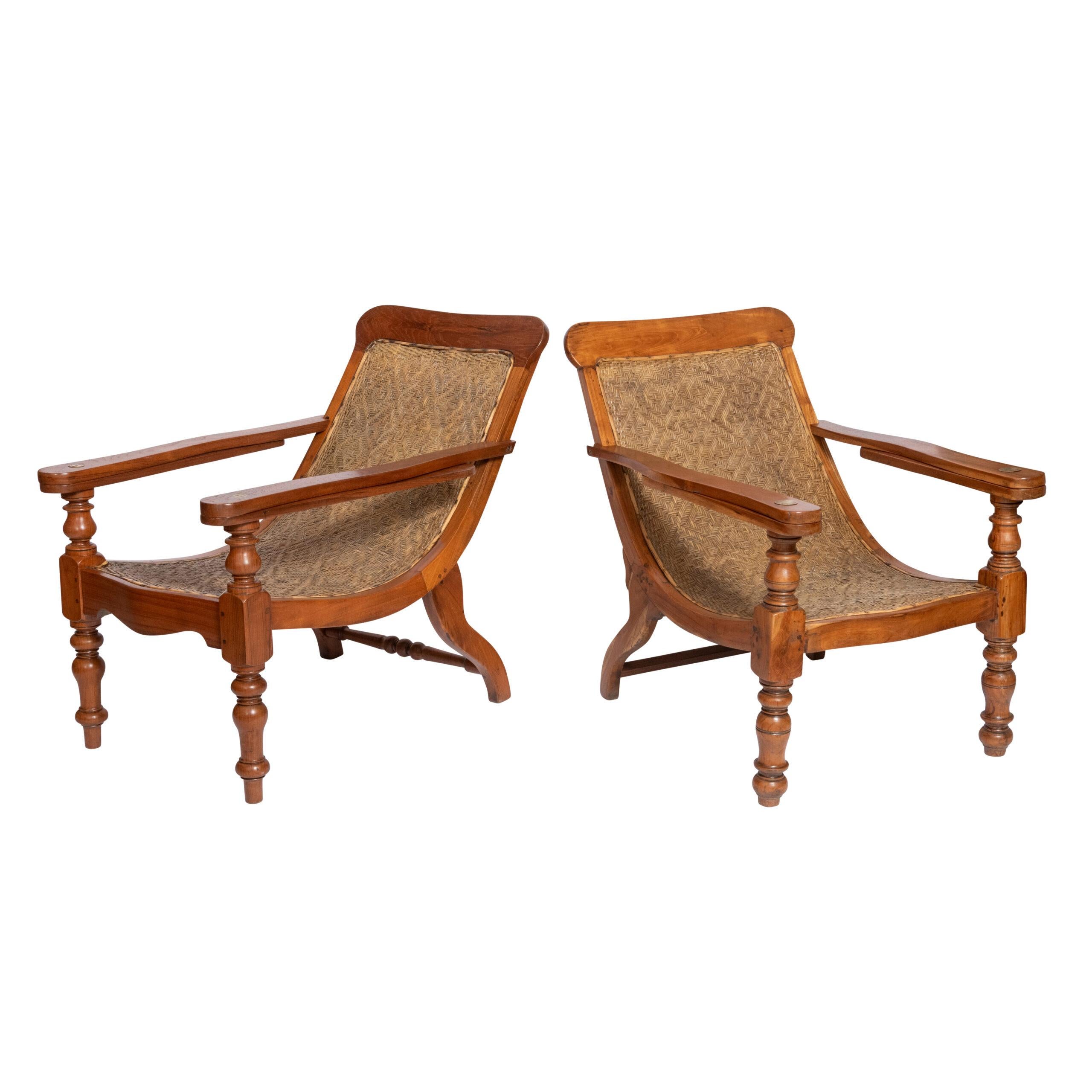 A pair of Anglo Indian Plantation Chairs.

Teak, original rattan woven back.

India, circa 1900.

88 cm high x 68 cm wide x 102 cm deep