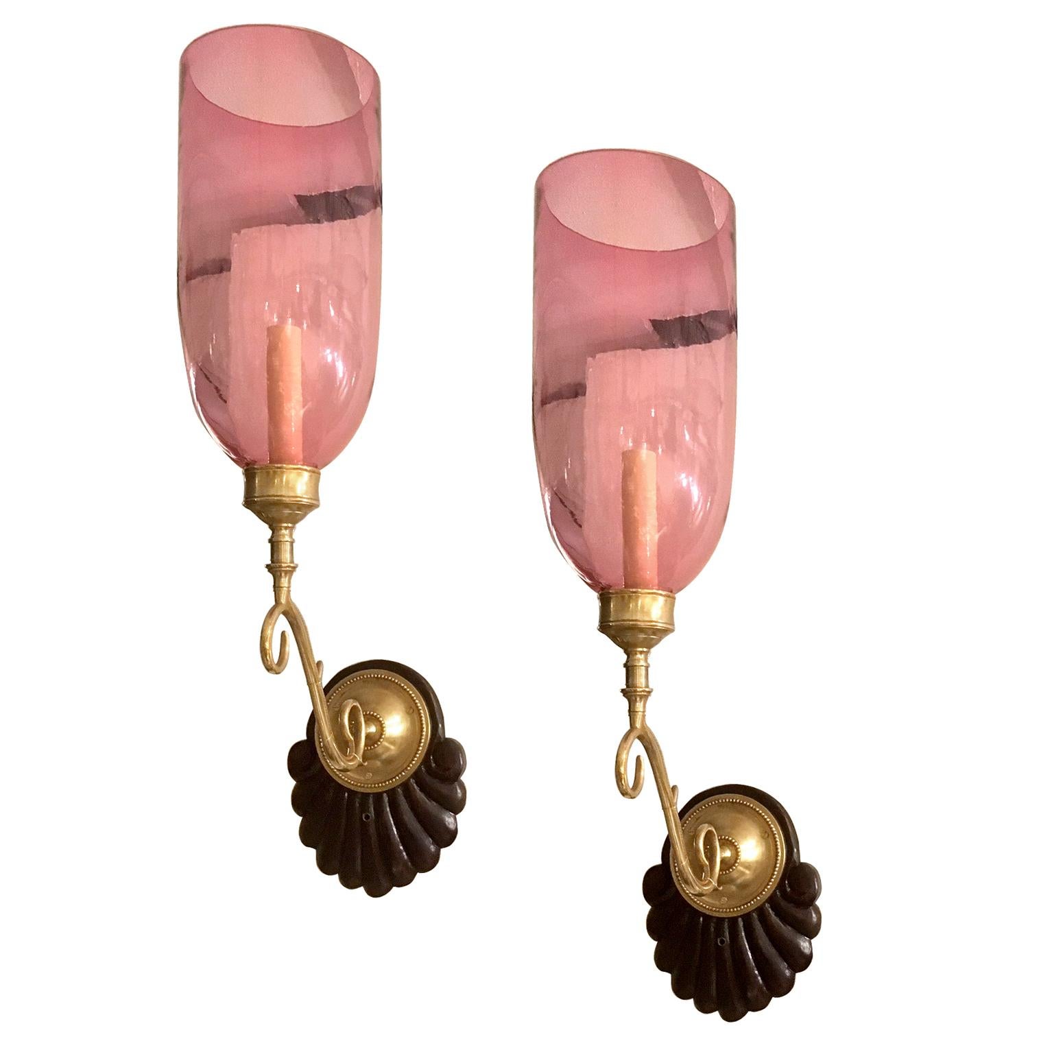 Pair of circa 1900 Anglo Indian single-light sconces with carved wood backplates and ruby red glass hurricanes.

Measurements:
Height 24