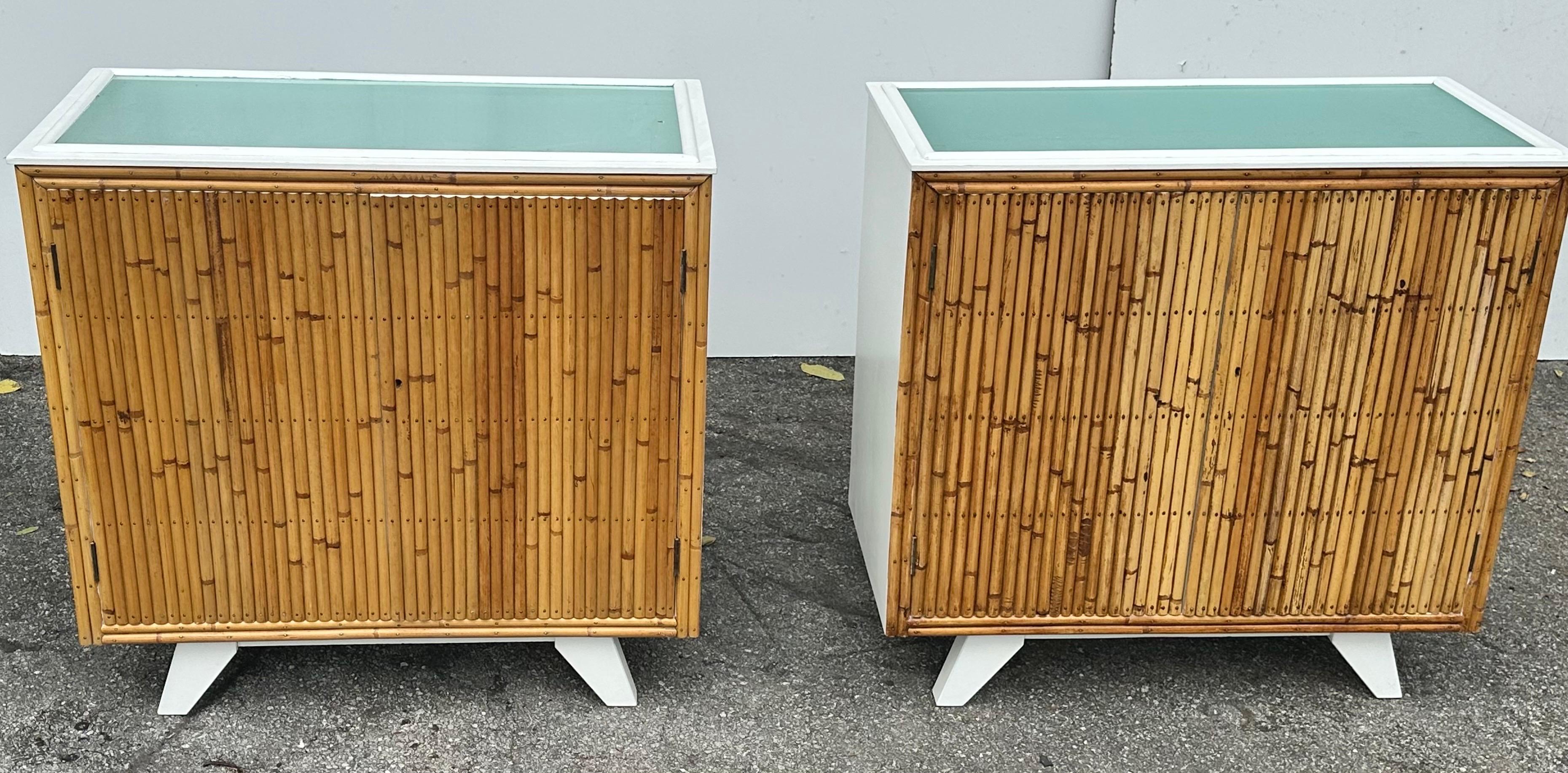 Pair of signed Angrave’s English Glass top Bamboo Cabinet.
Refinished in white .
 Original Glass shelve.