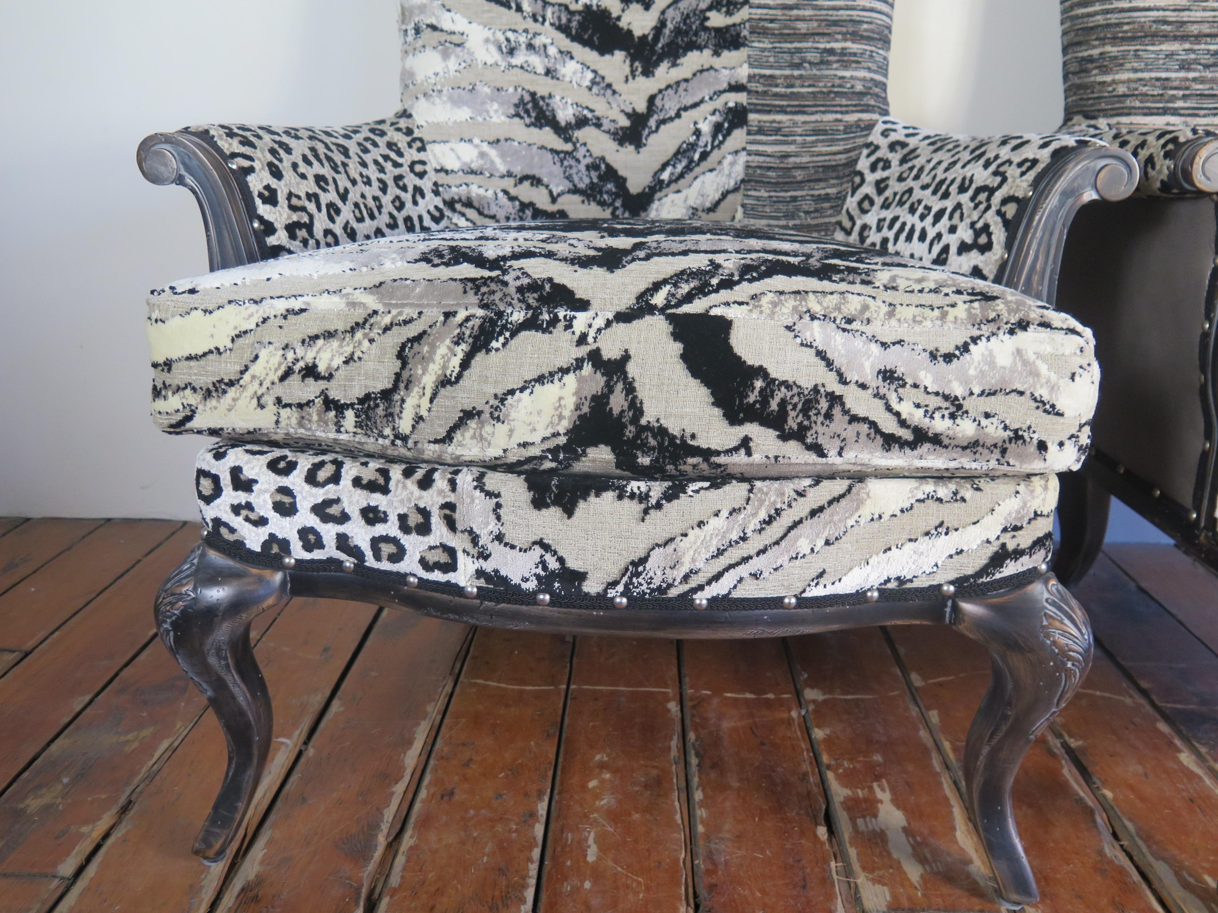 Pair of animal print asymmetrical chairs with leather and nailhead detail.