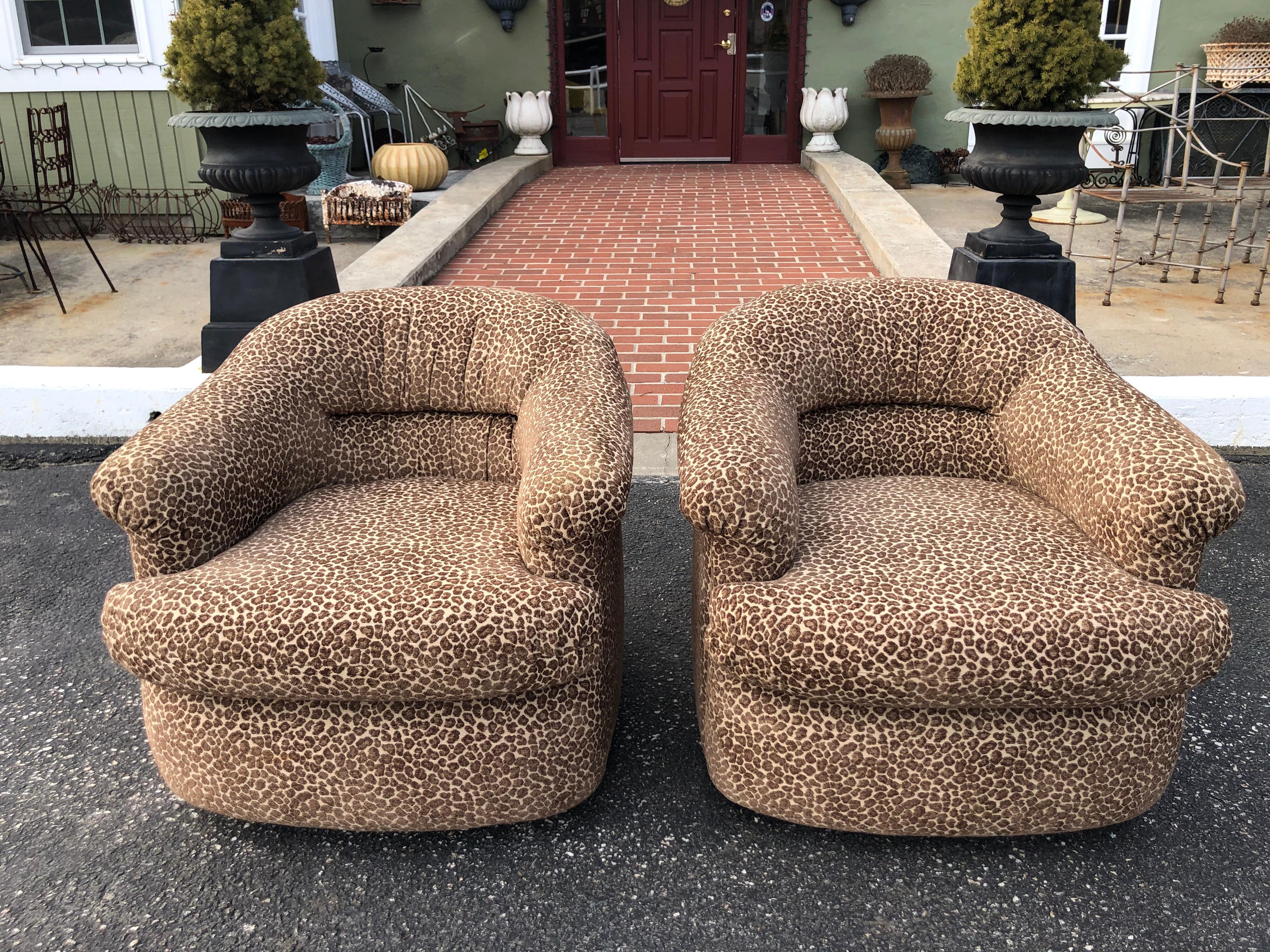 Pair of Mid Century club chairs on casters freshly recovered in animal print upholstery. Sink into these soft chenille plush chairs . Perfect for a bedroom or living room. Only two colors: brown and beige. There is no black in this fabric. Nice