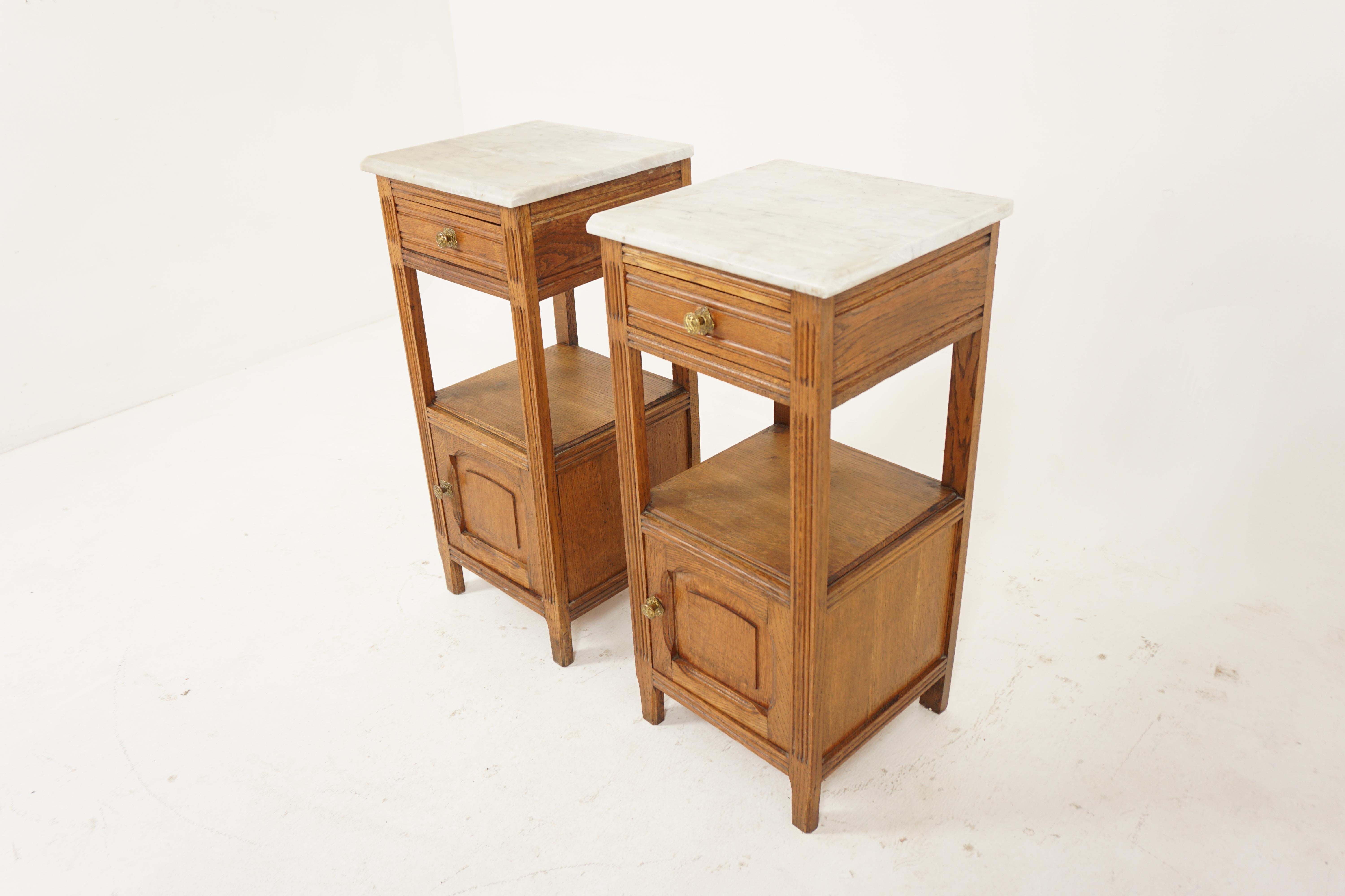 Pair of Antique French marble top oak nightstand bedside, lamp tables, France 1900, B2927

France 1900
Solid Oak
Original Finish
White marble top 
Below single beveled drawer with original brass hardware
Open shelf underneath
Single paneled