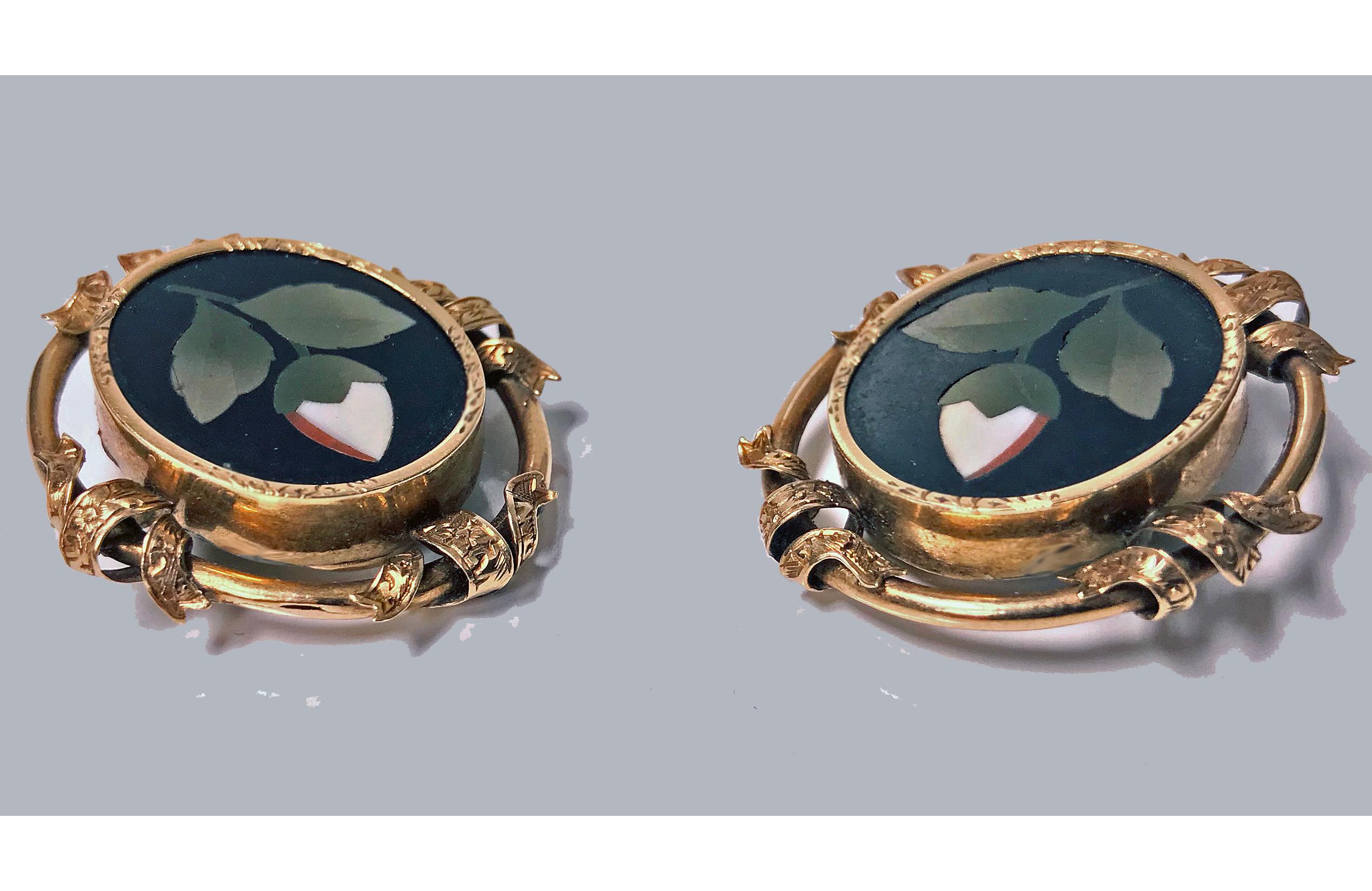 Pair of antique 14-karat Pietra Dura earrings, circa 1875. Each of oval form, bezel set oval Pietra Dura floral white, green orange inlay colours, the surround gold mount interspaced ribbon design, clip fitments. Gold acid tests 14-karat. Measures: