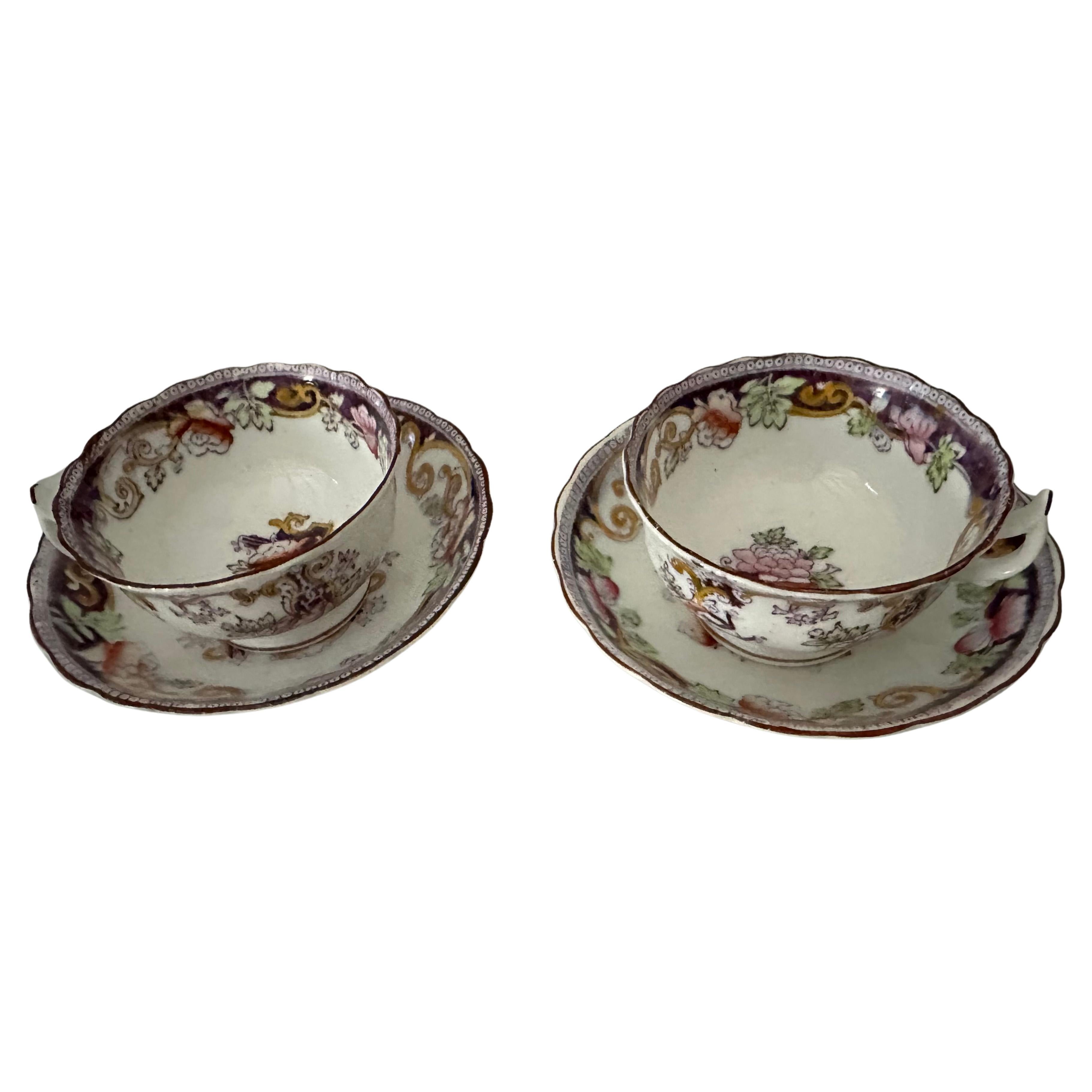 Treat yourself and a friend to enjoying a perfect cup of tea with this fine pair of antique Victorian 1890 English bone china cup and saucer sets.  The sets are embellished in a royal purple with some pink, green and gold floral and scroll