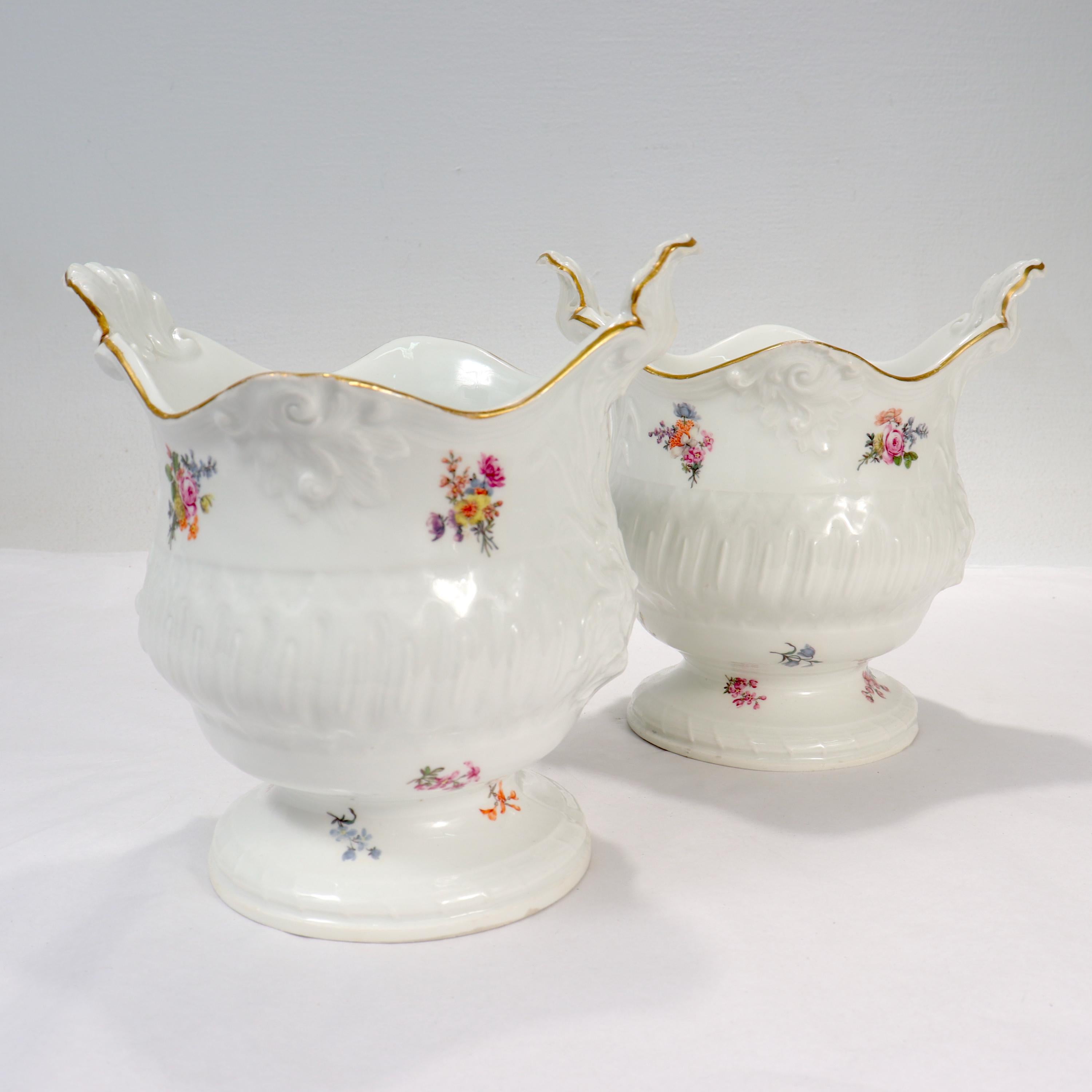 A fine pair of antique Meissen cachepots.

With baluster form bodies, shell handles, raised shell & cattail decoration to the sides, and handpainted floral sprays throughout.

Dating to the late 18th or early 19th century.

Simply a fine and
