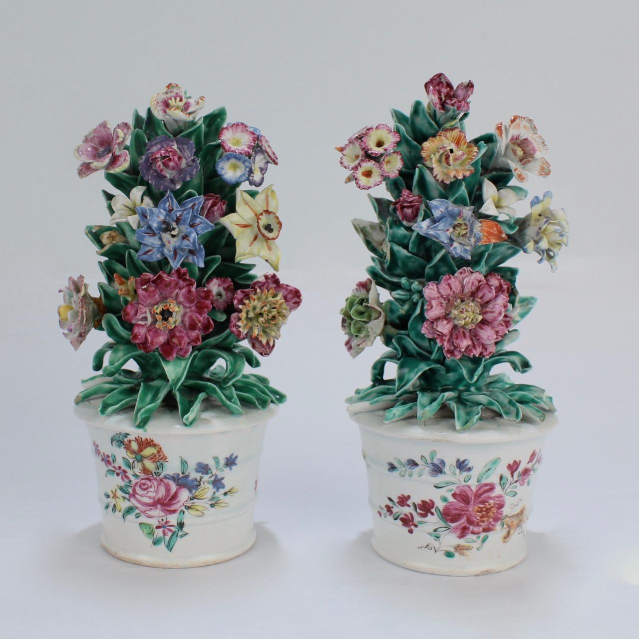 A very rare pair of antique English soft paste porcelain cachepots with flower encrusted bouquets with very good form and color.

Each modeled as miniature flower pot filled with bocage style porcelain floral arrangement decorated in polychrome