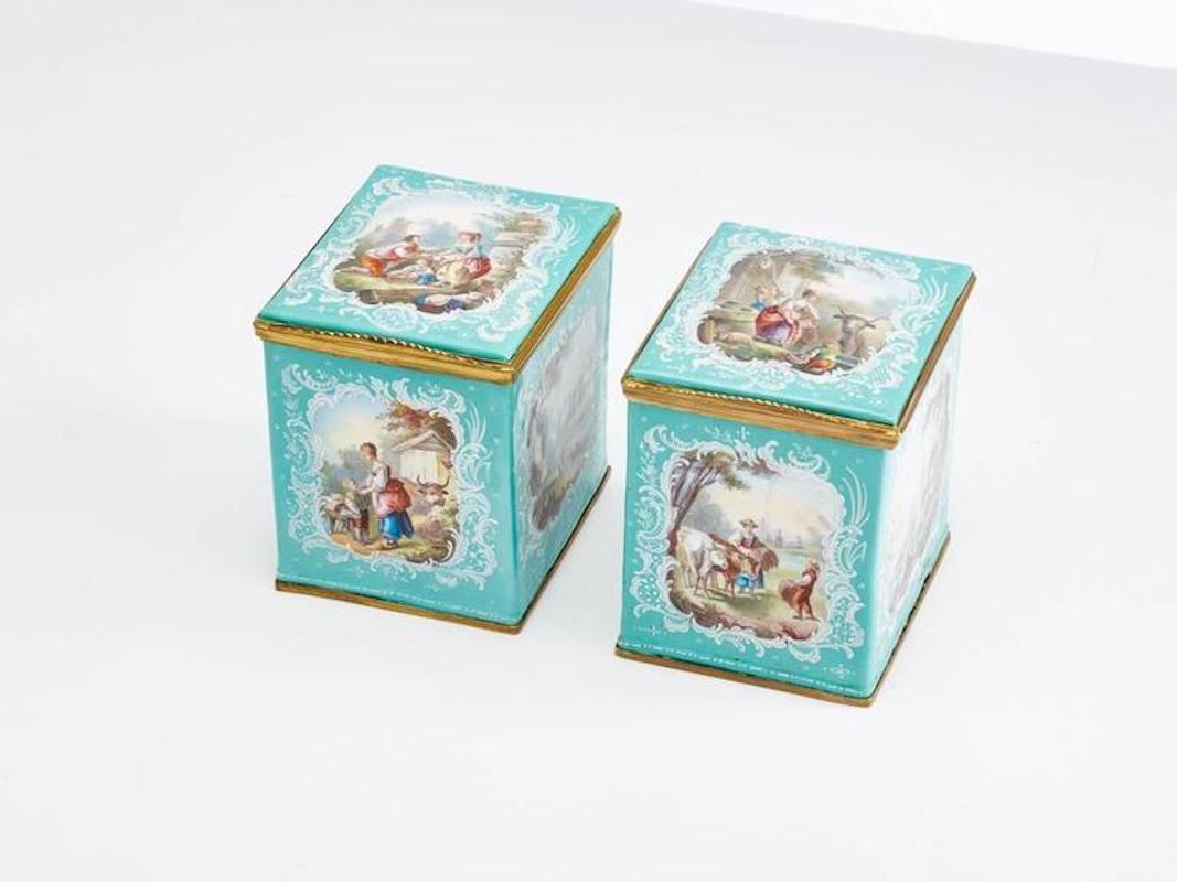 Pair of 18th century French enamel tea caddies in excellent condition.
The exterior pastoral scenes on each panel including the lids are all well executed. 

The interiors are clean with just a small blemish on one caddy just under the lid just