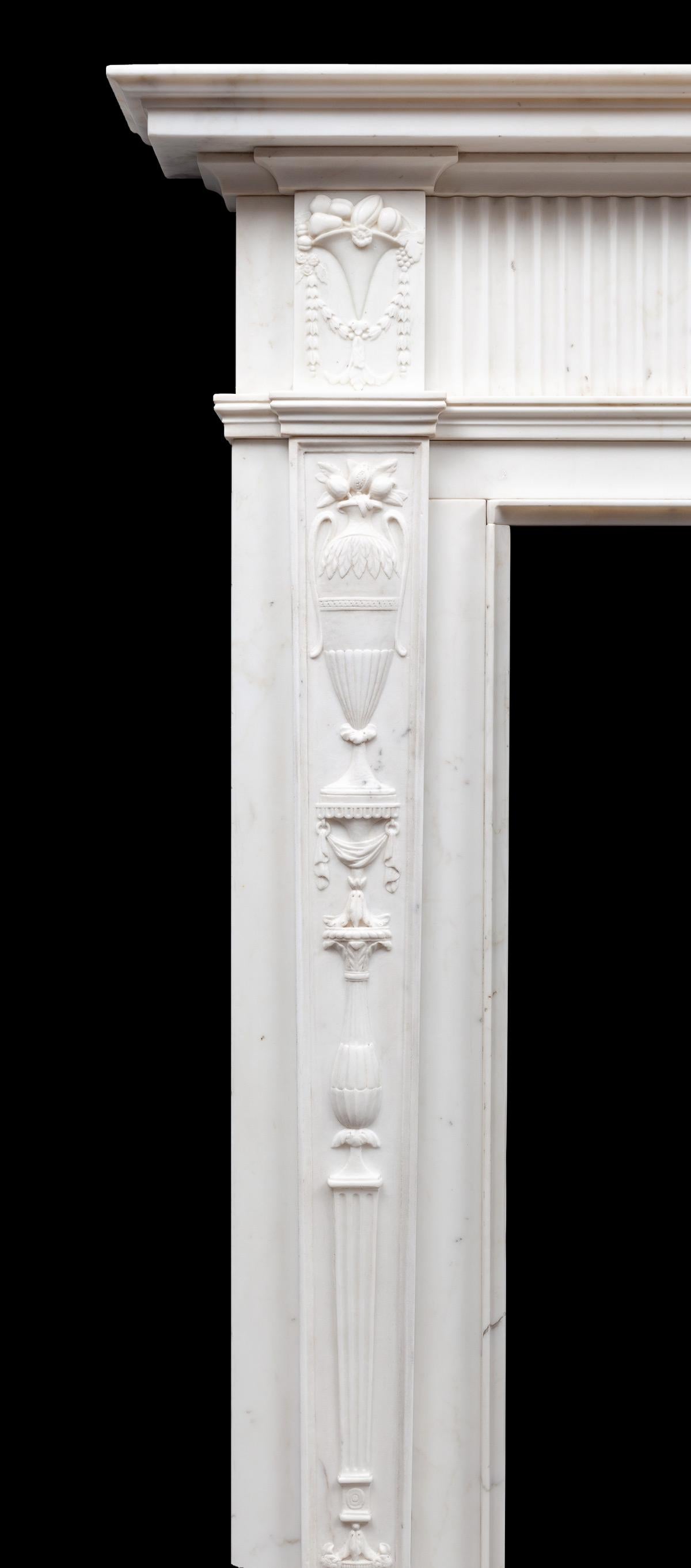 An outstanding and rare pair of Irish, late 18th century Statuary Carrara marble chimneypieces. The tall and elegant tapering pilasters are finely carved with neo-classical ornament, the classical urn centre tablet is flanked by fluted panels and