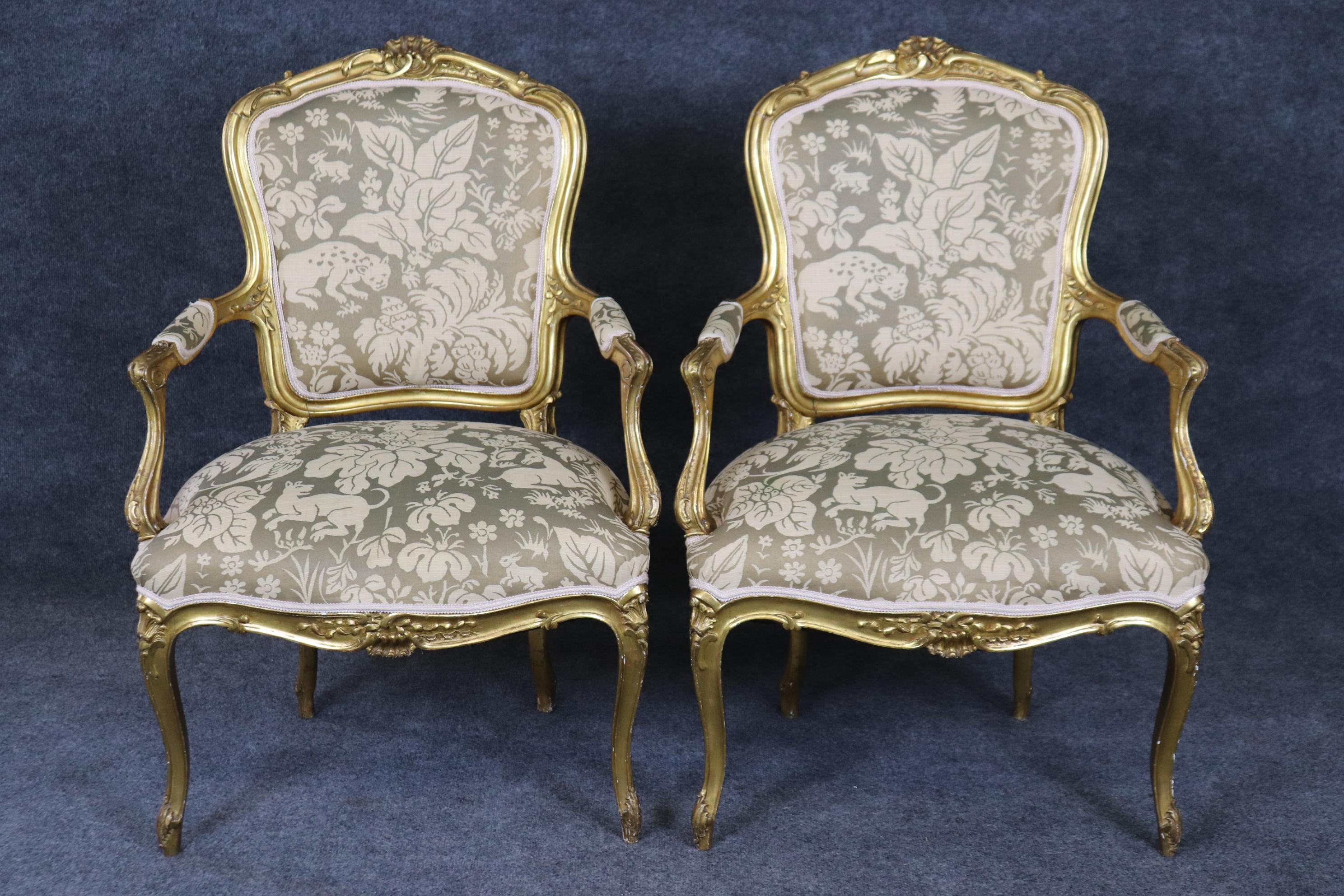 This is a superb gold gilded French Louis XV armchairs with a delightful jungle themed animal printed upholstery with deer, leopards and lions basking in flowers. The color is neutral and will work with most shades in your room and the superb carved