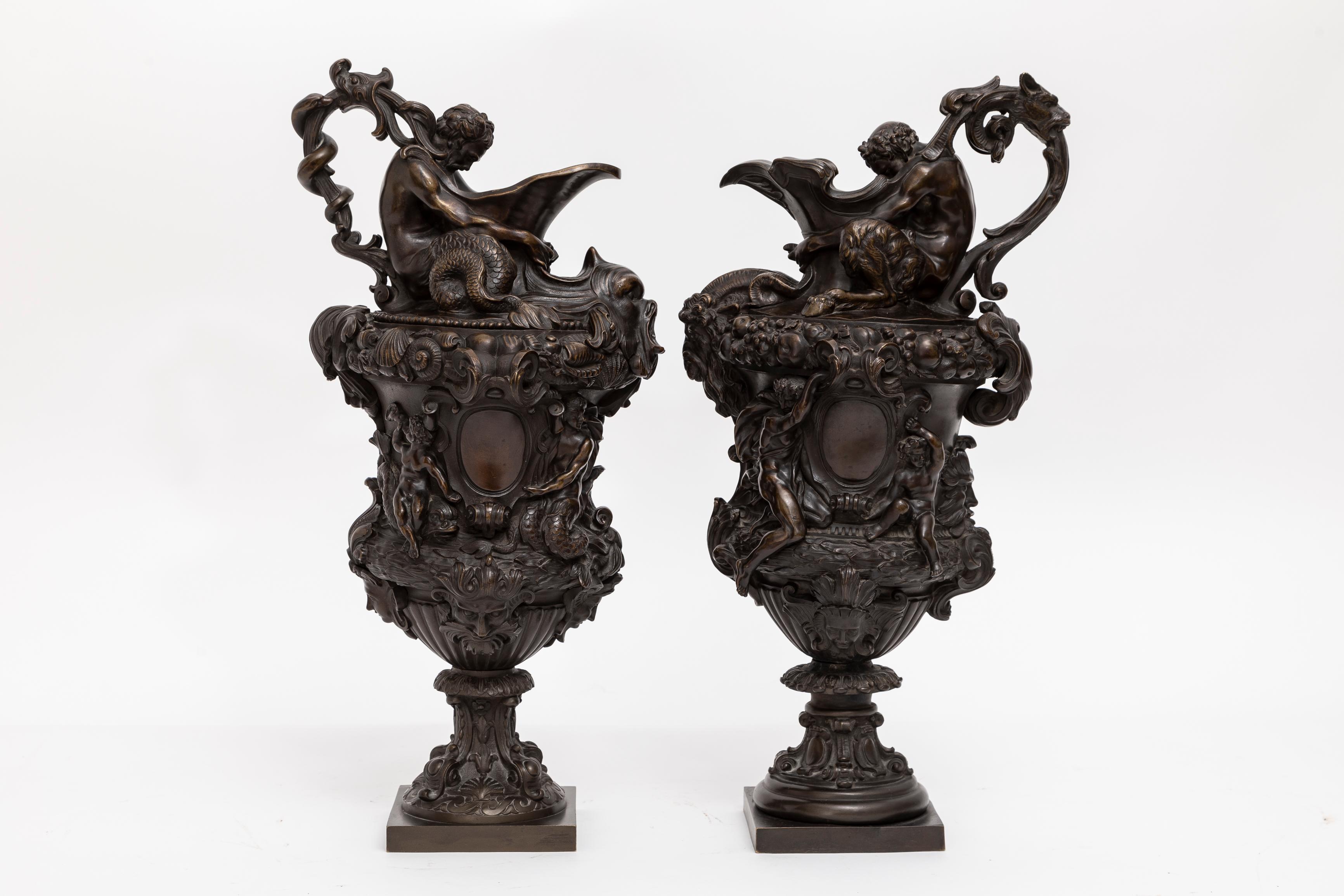 A Fabulous Pair of Antique 19th Century French Patinated Bronze Ewers Emblematic of Water & Earth.  These are a popular and well-known model of ewers named 