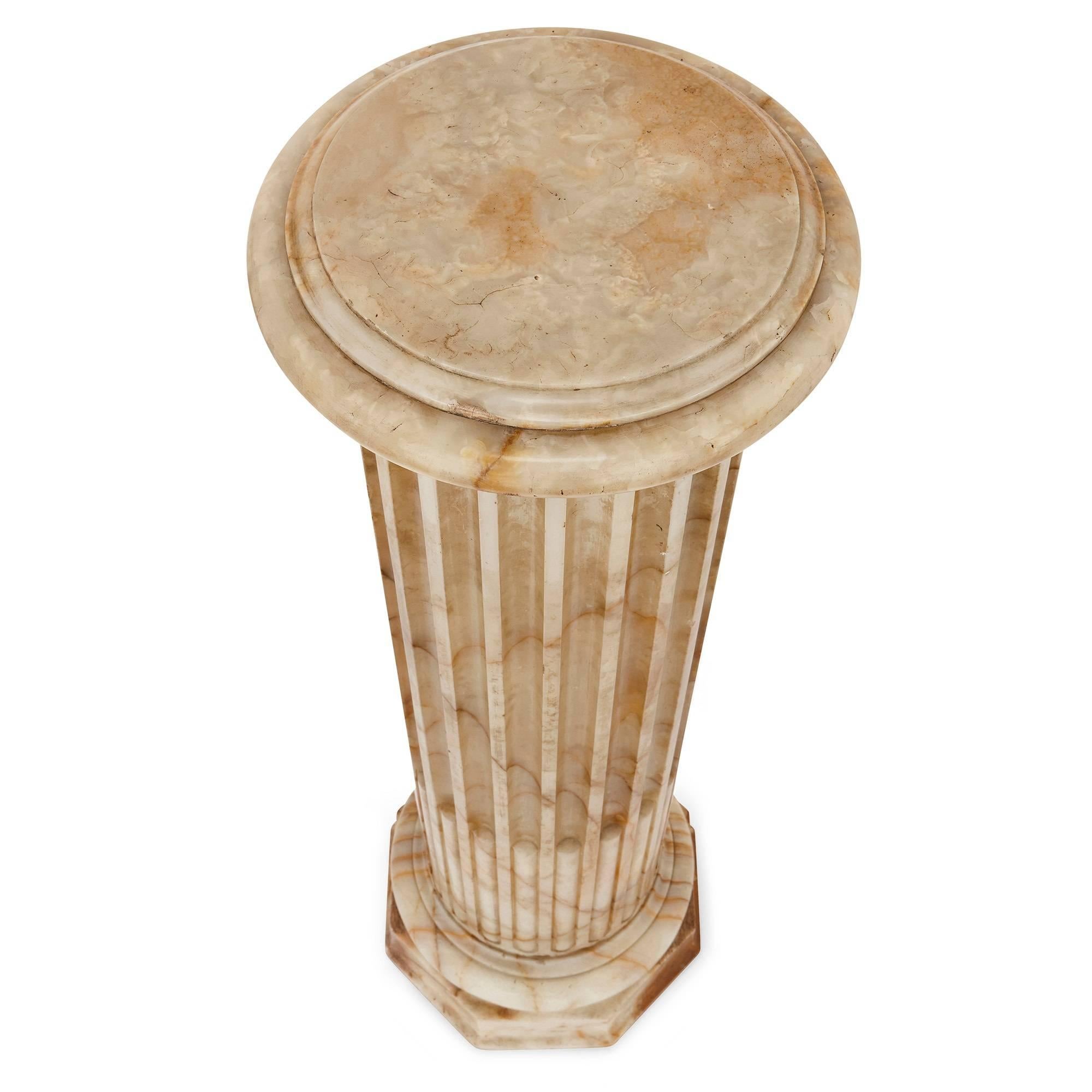 Made at the height of the vogue for neoclassical design in the 19th century, these pedestals will make a fine addition to a classical interior setting. These are Doric order columns, built from the cream-colored mineral alabaster. The lower half of