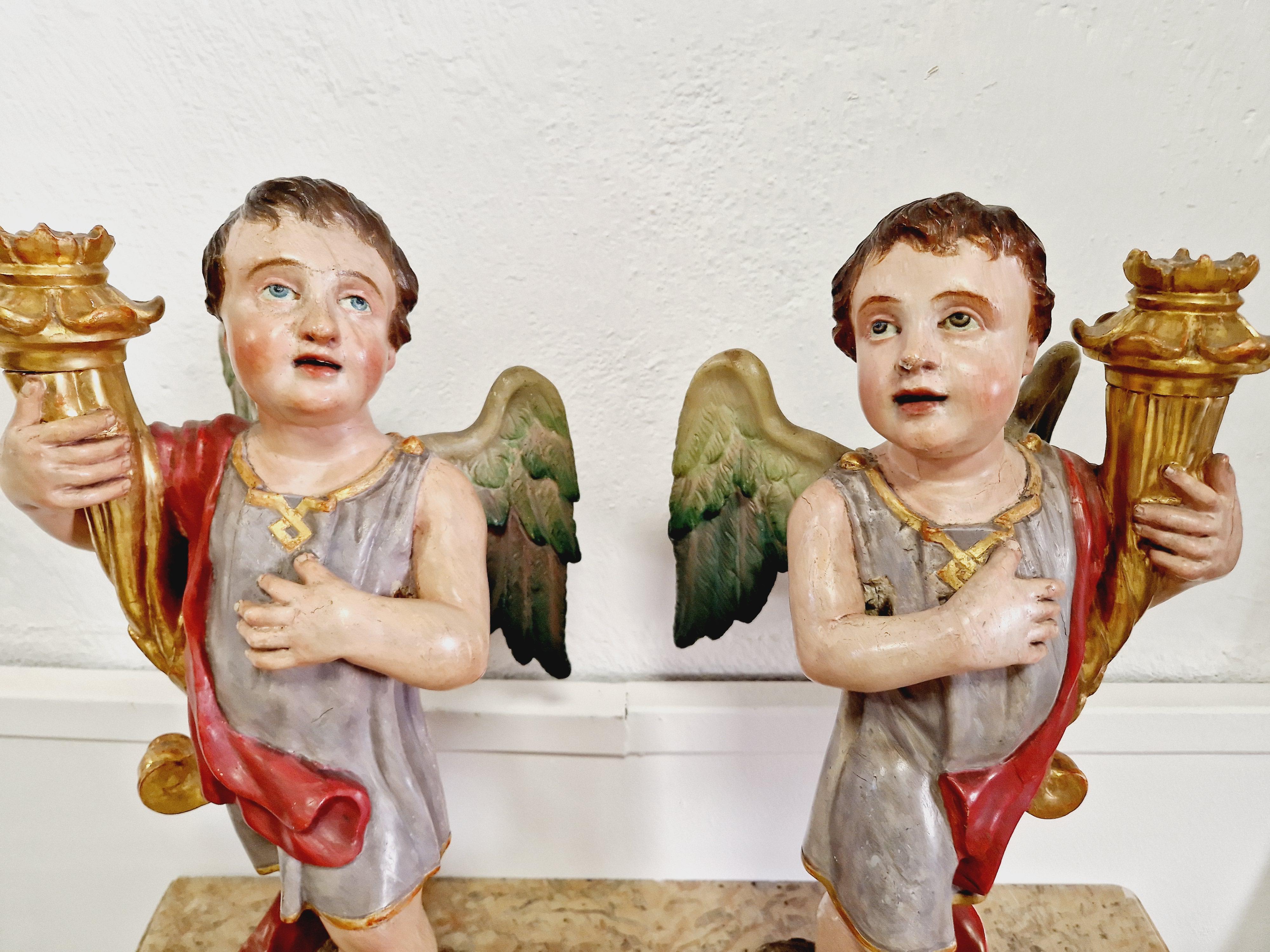This pair of fabulous antique 19th century angel torch holders are a stunning addition to any art collection. Crafted from polychromed wood and featuring intricate carvings, these statues are a beautiful representation of the Baroque/Roccoco period.