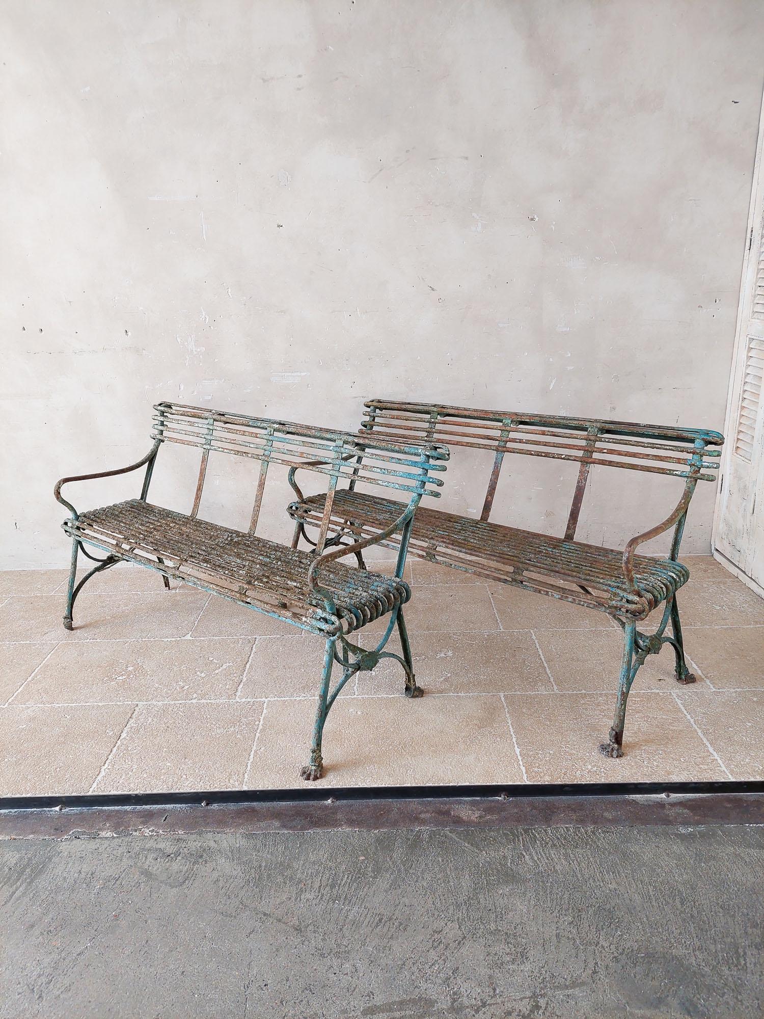 Pair of antique Arras garden benches with claw feet, and original worn green patina. From the 19th Century. Some claw feet are missing due to age.

h 75 x w 140 x d 50 cm

The French antique garden furniture style Arras is named after the town where
