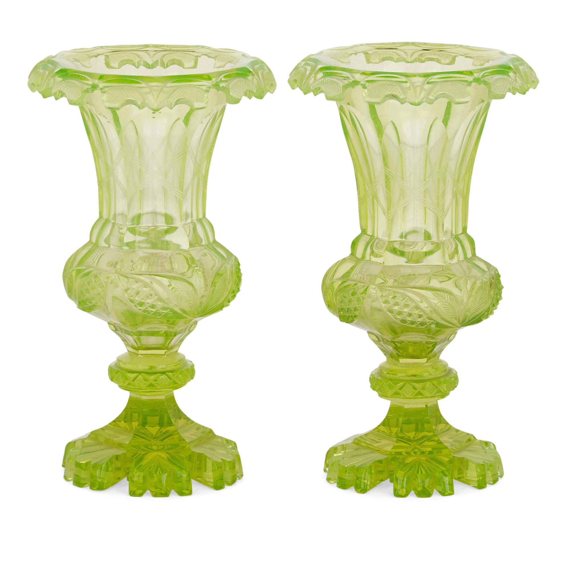 Pair of antique 19th century bohemian green cut glass vases
Bohemian, circa 1870
Dimensions: Height 23cm, diameter 13cm

Cut from uranium glass, this vibrant pair of green Bohemian vases are designed in the style of a campana vase. They feature