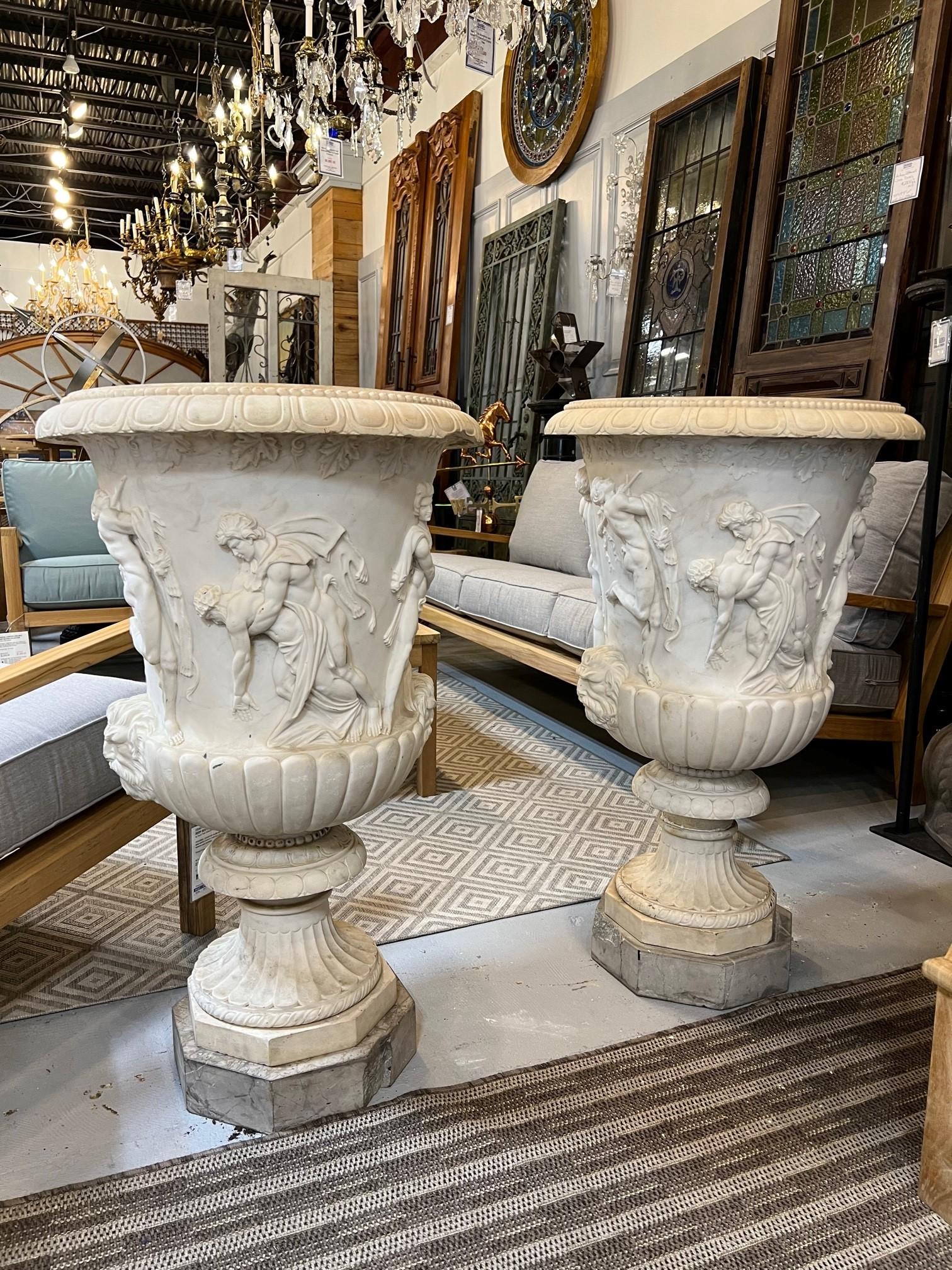 A very fine and exceptionally handed carved pair of Italian Early 20th century marble urns. A great size and intricately designed with male and female figures dancing and playing musical instruments, the details are amazing. The marble urns are each