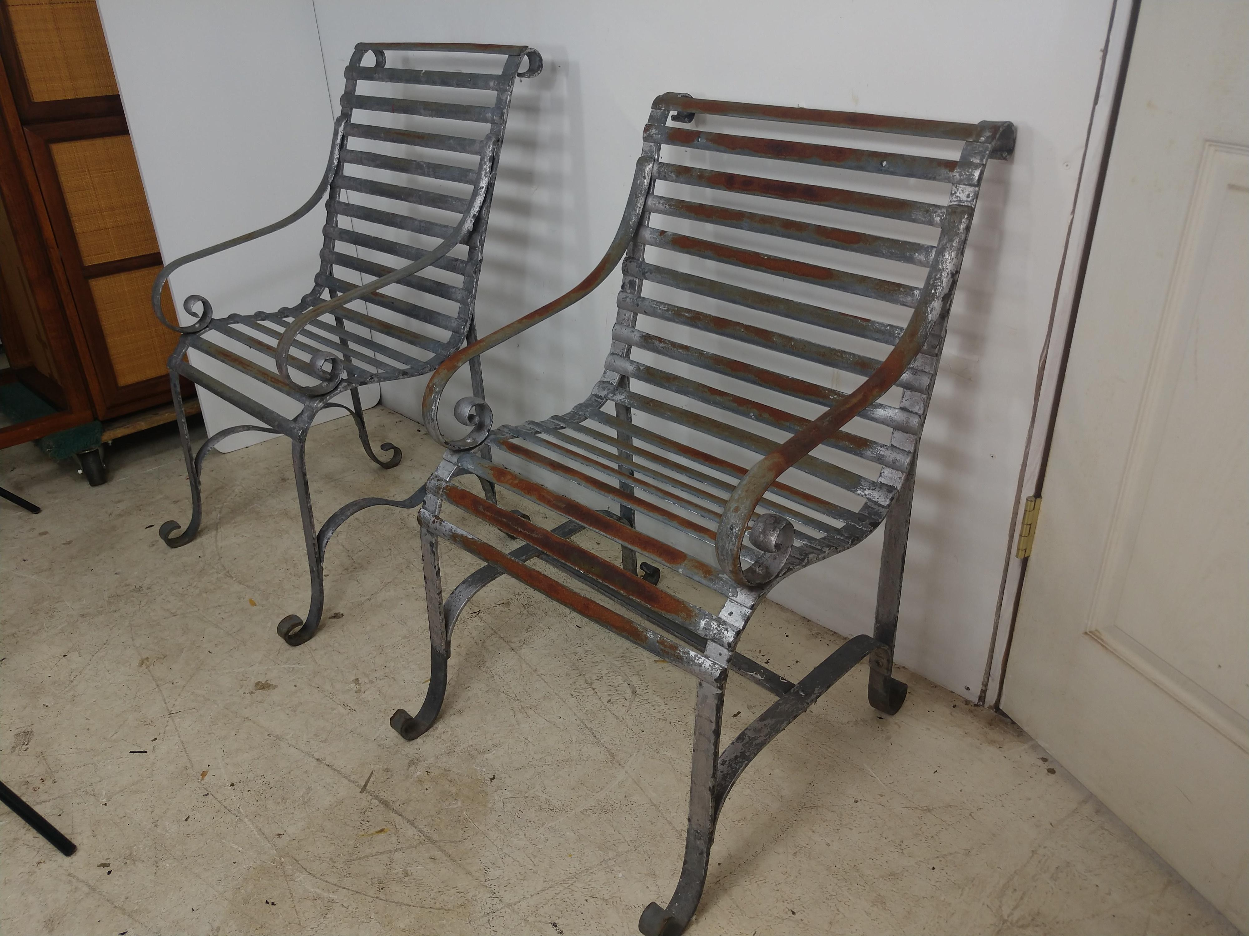 Excellent pair of zinc coated, (galvanized), strap armchairs. In excellent vintage condition with minimal wear, some surface rust, patina, well maintained with original paint. Priced and sold as a pair. Seat hgt is 17.25.