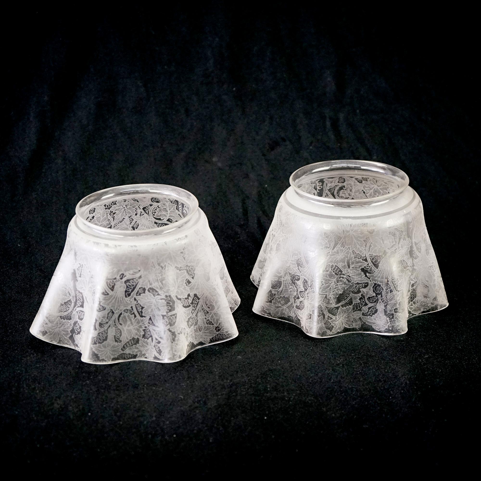 An antique pair of gas light shades offer glass construction with ruffled rims and allover leaf and vine design, c1890

Measures- 5.5''H x 8.75''W x 8.75''D.