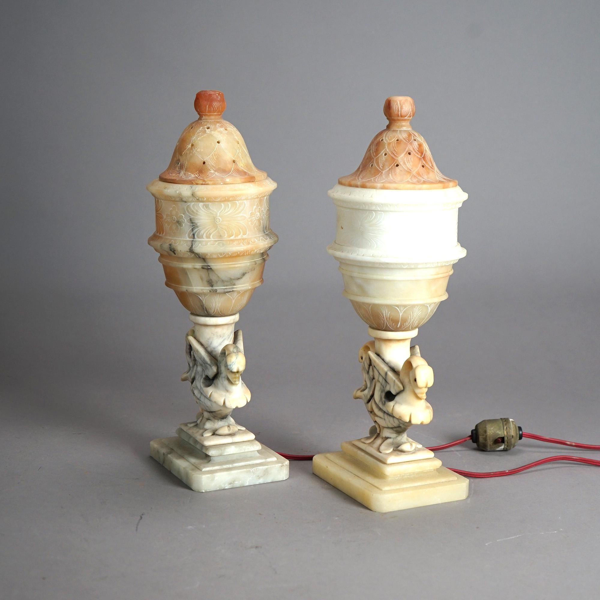A pair of antique figural boudoir lamps offers alabaster construction with stylized urn form shades over carved bases with swan; c1920

Measures - 14.75