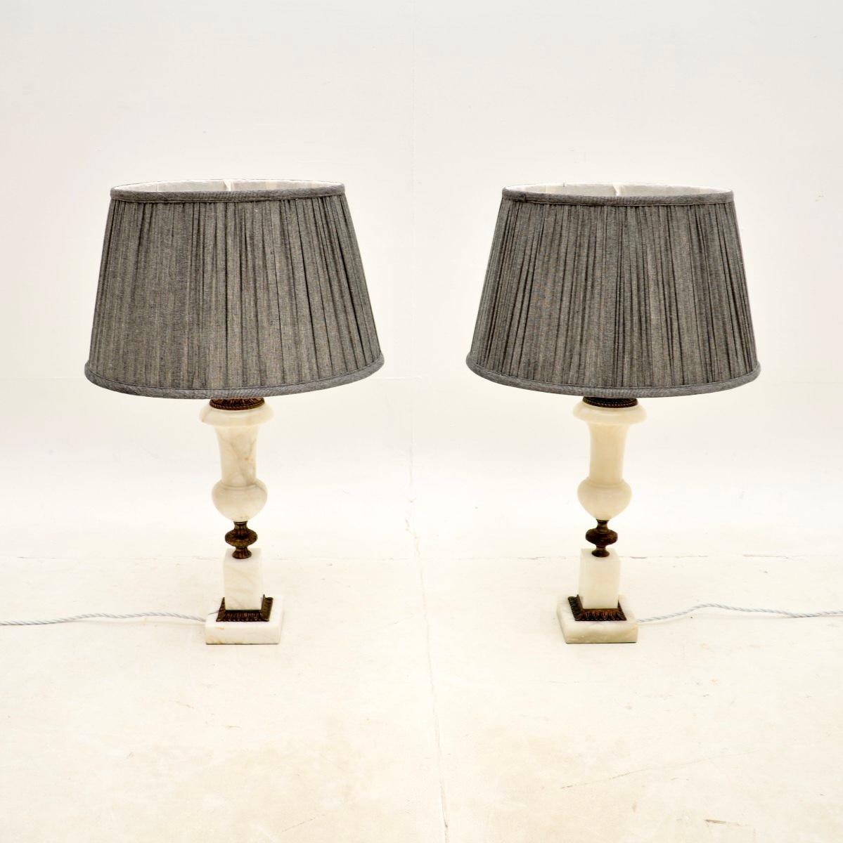 A beautiful pair of antique alabaster table lamps. They were most likely made in France, they date from around the 1930’s.

The quality is excellent, the alabaster is a beautiful white colour with tones of grey running through. They are held