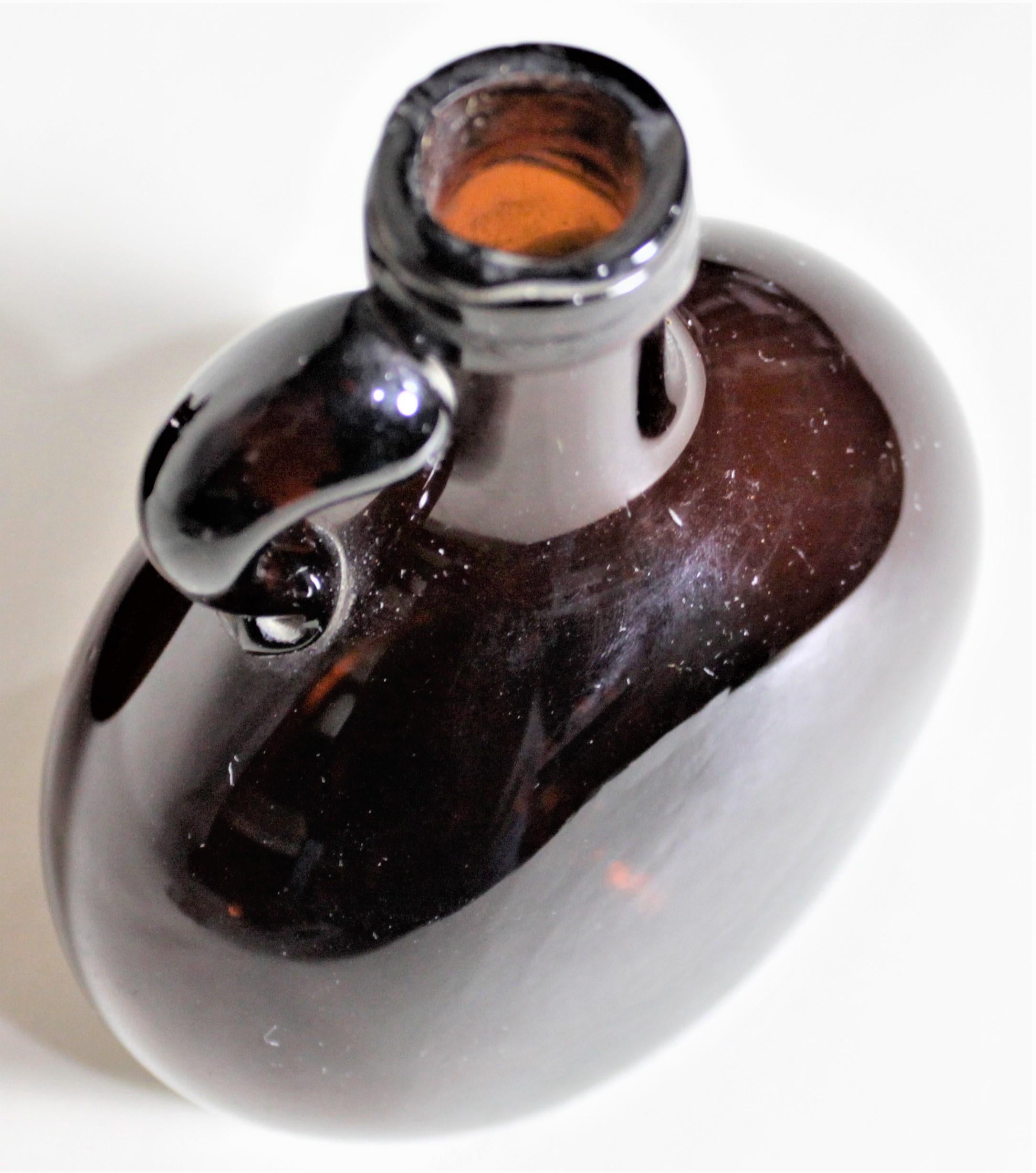 Hand-Crafted Pair of Antique Amber Glass Liquor Decanters with Mother of Pearl Stoppers For Sale