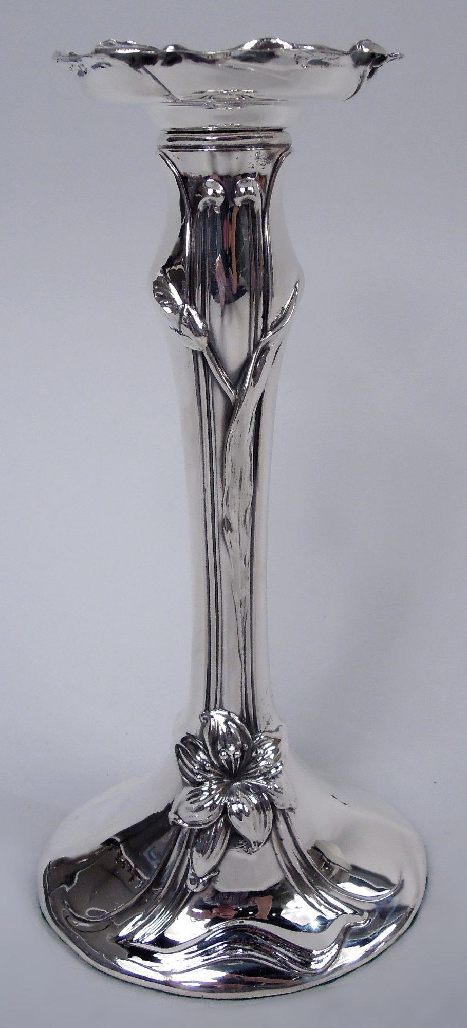 Pair of Art Nouveau sterling silver candlesticks. Made by Woodside Sterling Co. in New York, ca 1900. Columnar baluster shaft on domed oval foot with budding stems and flowerheads applied over curvilinear tendril frames; bobeche irregular with same.