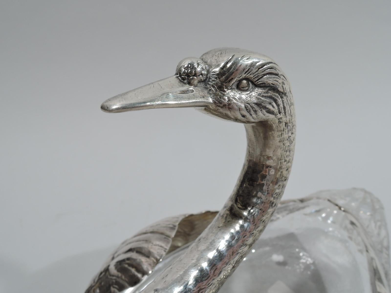 Pair of American Edwardian sterling silver and glass swans, ca 1920. Each: Glass body with imbricated tail feathers. Sterling silver mouth with plumy wings and graceful s-scroll neck and head with penetrating gaze and long and closed bill. Both