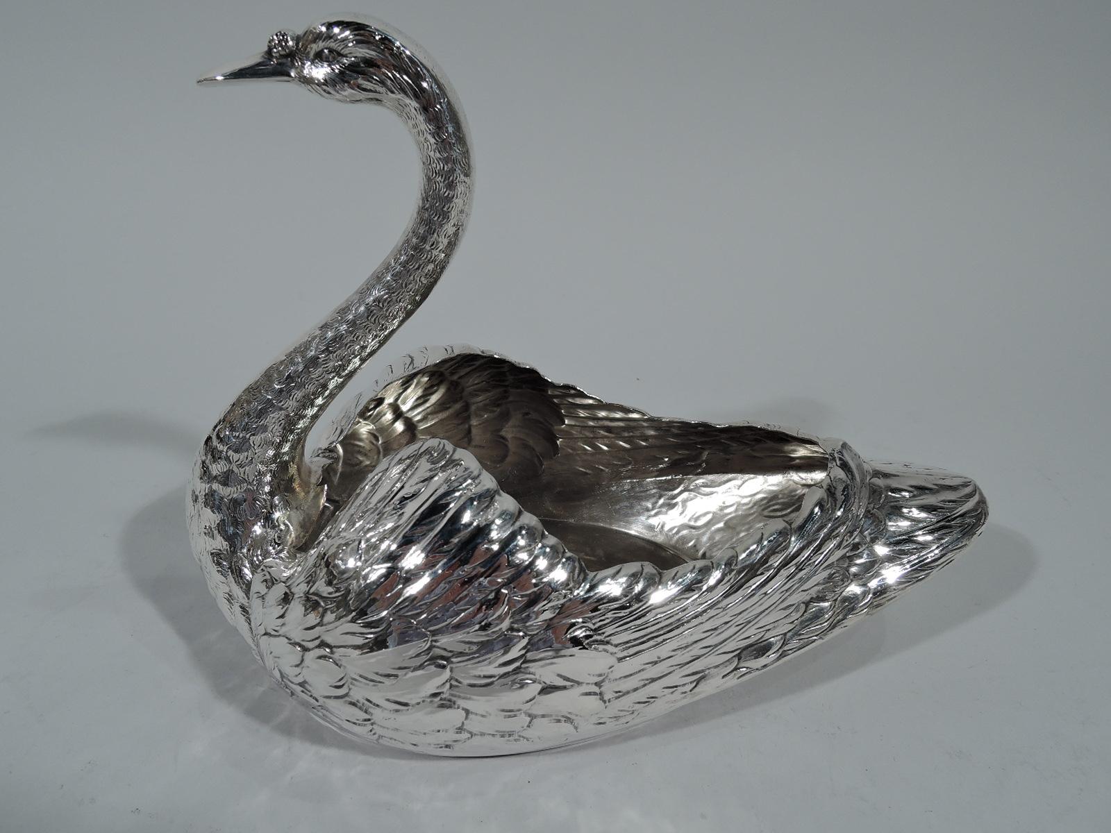 Pair of sterling silver swans. Made by Durgin (part of Gorham) in Concord, New Hampshire. Each: Distinctive feathering with downy plumed wings and scaly neck as well as closed bill and penetrating eyes. Hollow bodies waiting to be filled with