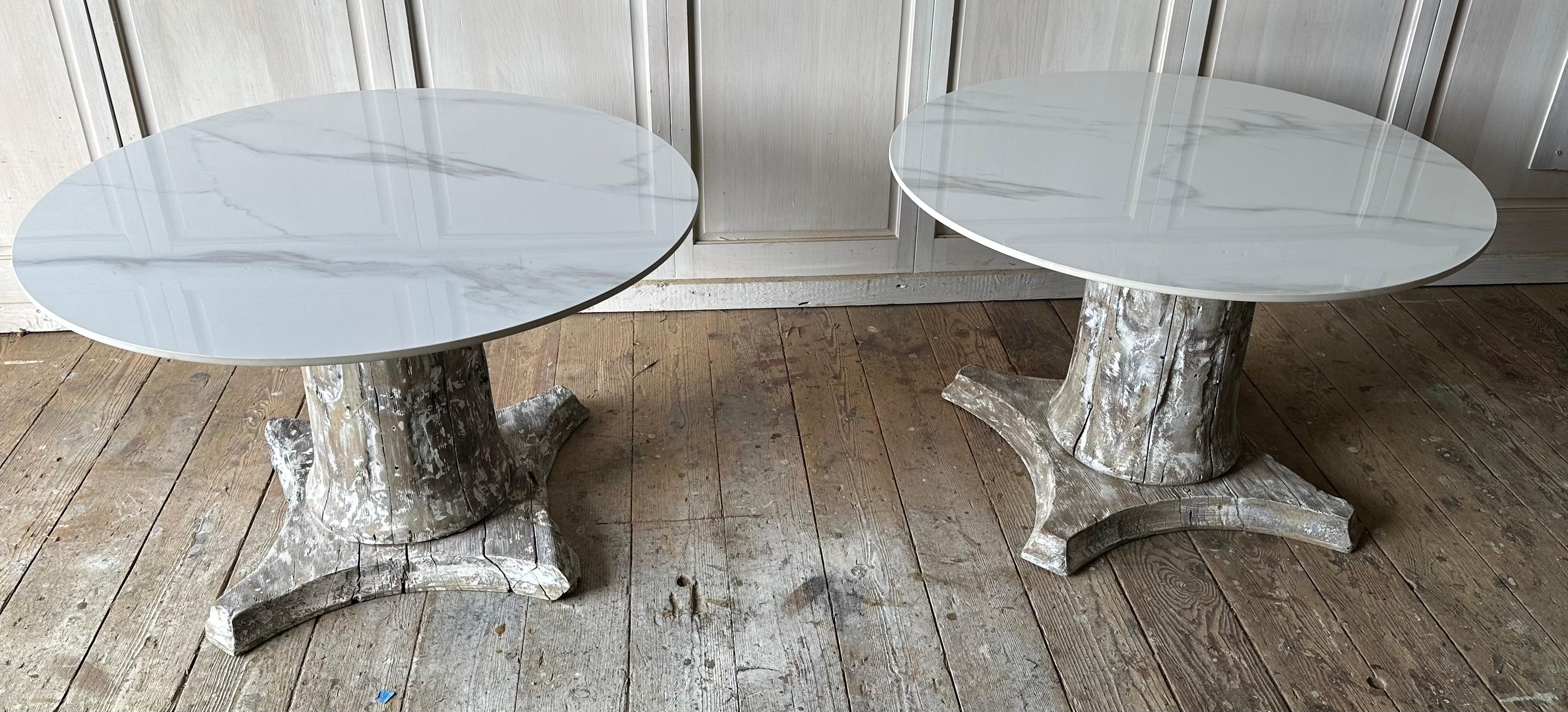 A marriage of old and the new, the pair rustic antique wooden column plinths, pedestals or bases in the classical style with faux marble tops, can be used as side tables, end tables, side by side as coffee tables  or pedestals for either indoor or