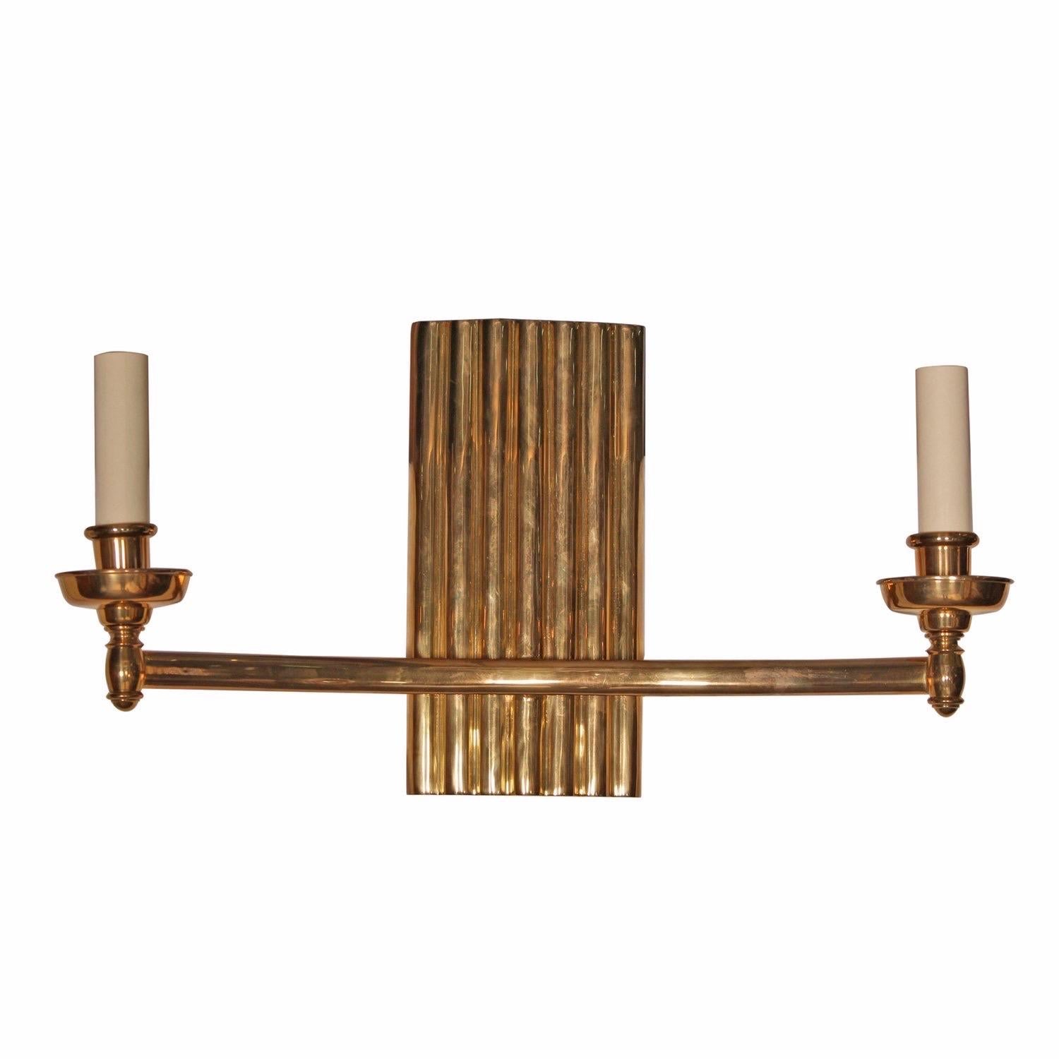 Pair of antique bronze sconces with double arms and ribbed back; highlighted by a high polished goldtone finish.

Dimensions (each) 23”W x 6.5”D x 12.2”H
