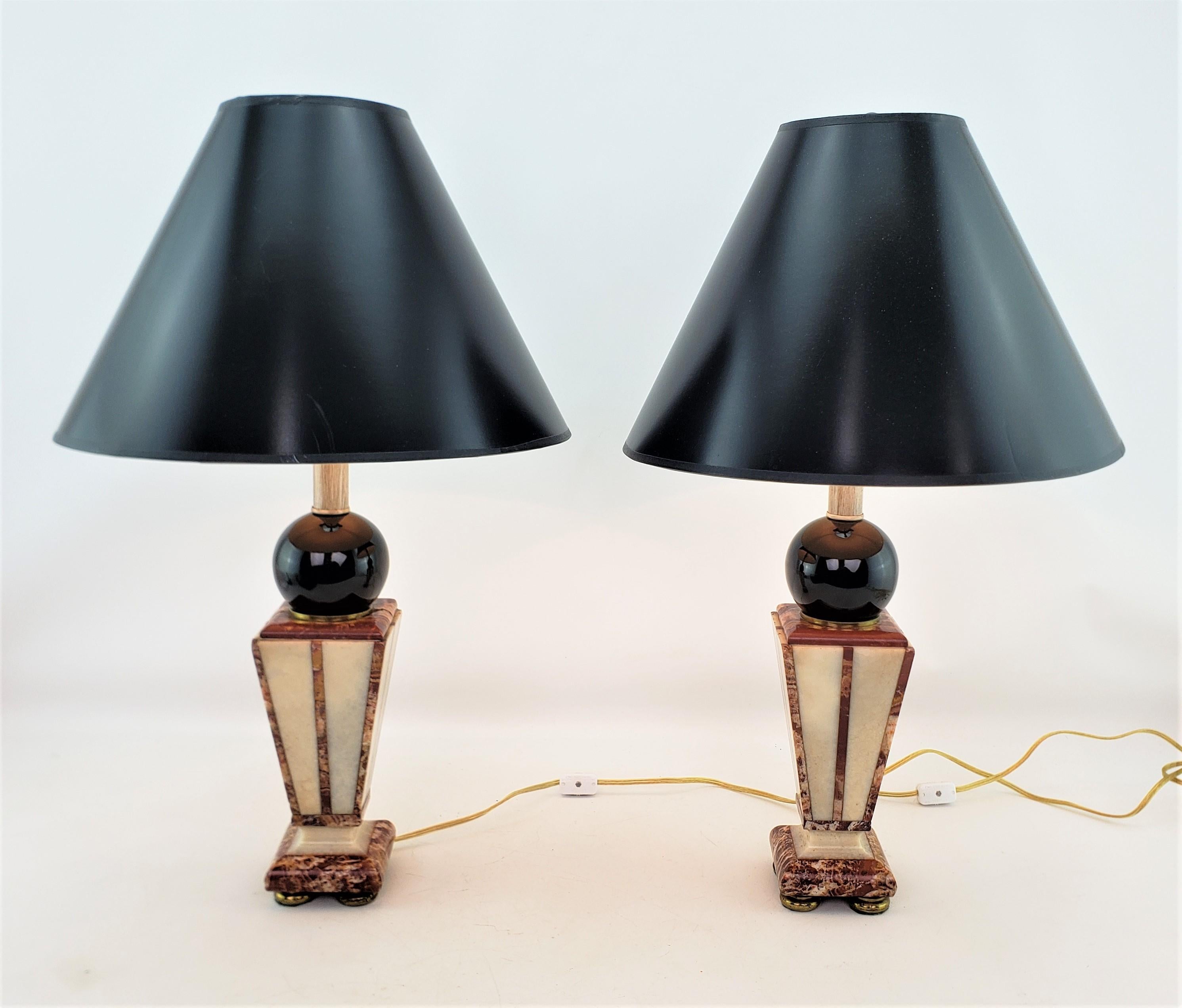 This pair of converted antique table lamps are unsigned, but presumed to have originated from Italy and date to approximately 1920 and done in the period Art Deco style. The lamp bases, which were once garnitures, are done in two tones of cut and