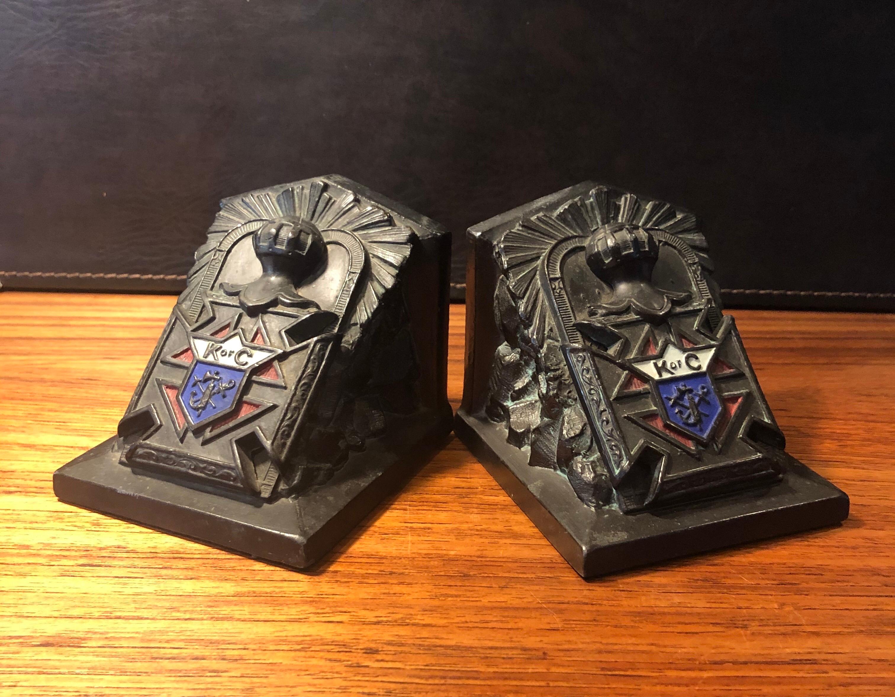 Fabulous pair of antique metal clad Art Deco Knights of Columbus (KOC) bookends by Ronson Art Metal Works, circa 1922. The pair have the KOC coat of arms in red, white and blue and are in great vintage condition. They measure 8.25