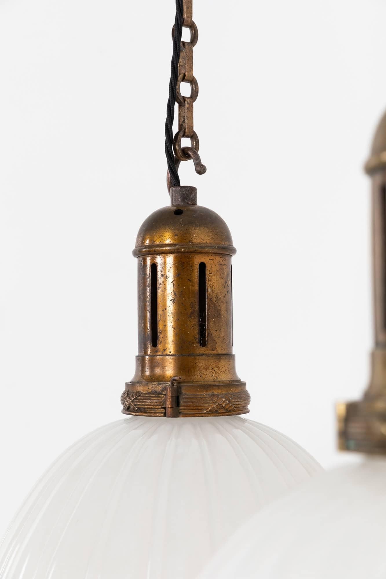 

An incredibly elegant pair of Jefferson Moonstone pendant lights. c.1920

Thick pressed moonstone glass of fluted design with original elongated cast brass GEC gallery. Glass tamped Jefferson to neck of the shade. Price is for the pair.

Rewired