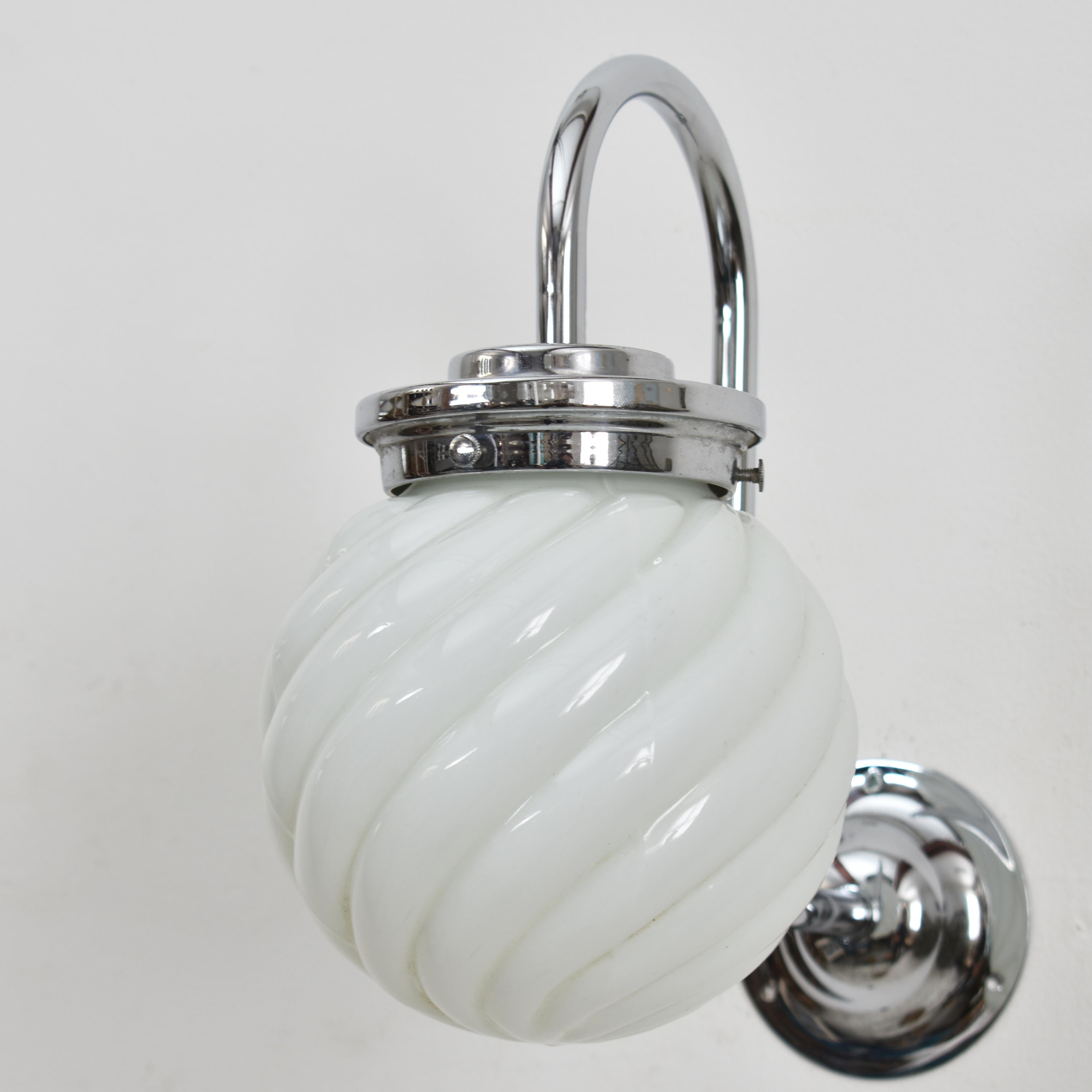Pair of Antique Opaline Wall Lights

A pair opaline wall lights with a chrome swan neck wall bracket and gallery. The opaline glass shades have an unique swirl shape to them.

Dimensions:
Shade height and diameter: 14cm
Light height including neck: