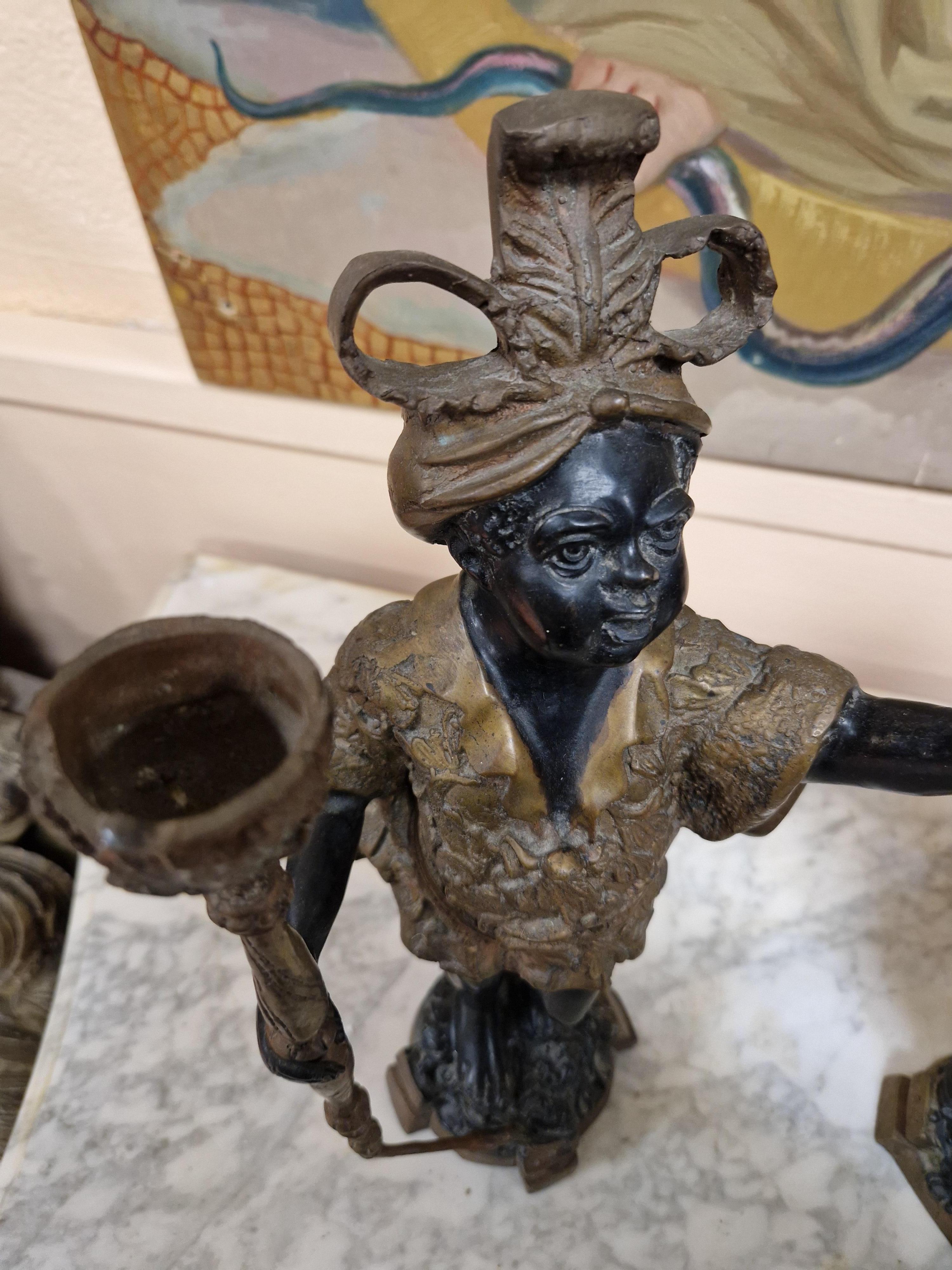 This exquisite pair of bronze candlesticks is a stunning example of 19th century Italian artistry. Handmade in Venetian style, these candlesticks feature a realistic style and are a beautiful addition to any collection. The intricate carving on the