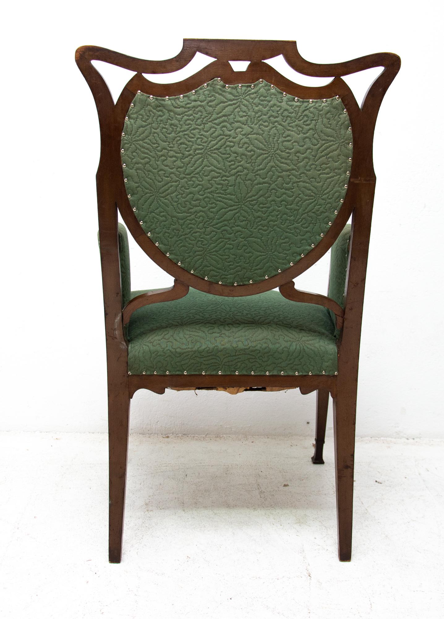 These beautiful Art Nouveau armchairs were made in Austria-Hungary, circa 1910. They are made of dark stained oakwood. They have an original upholstery. The chairs are structurally in good vintage condition. They have damaged upholstery at the