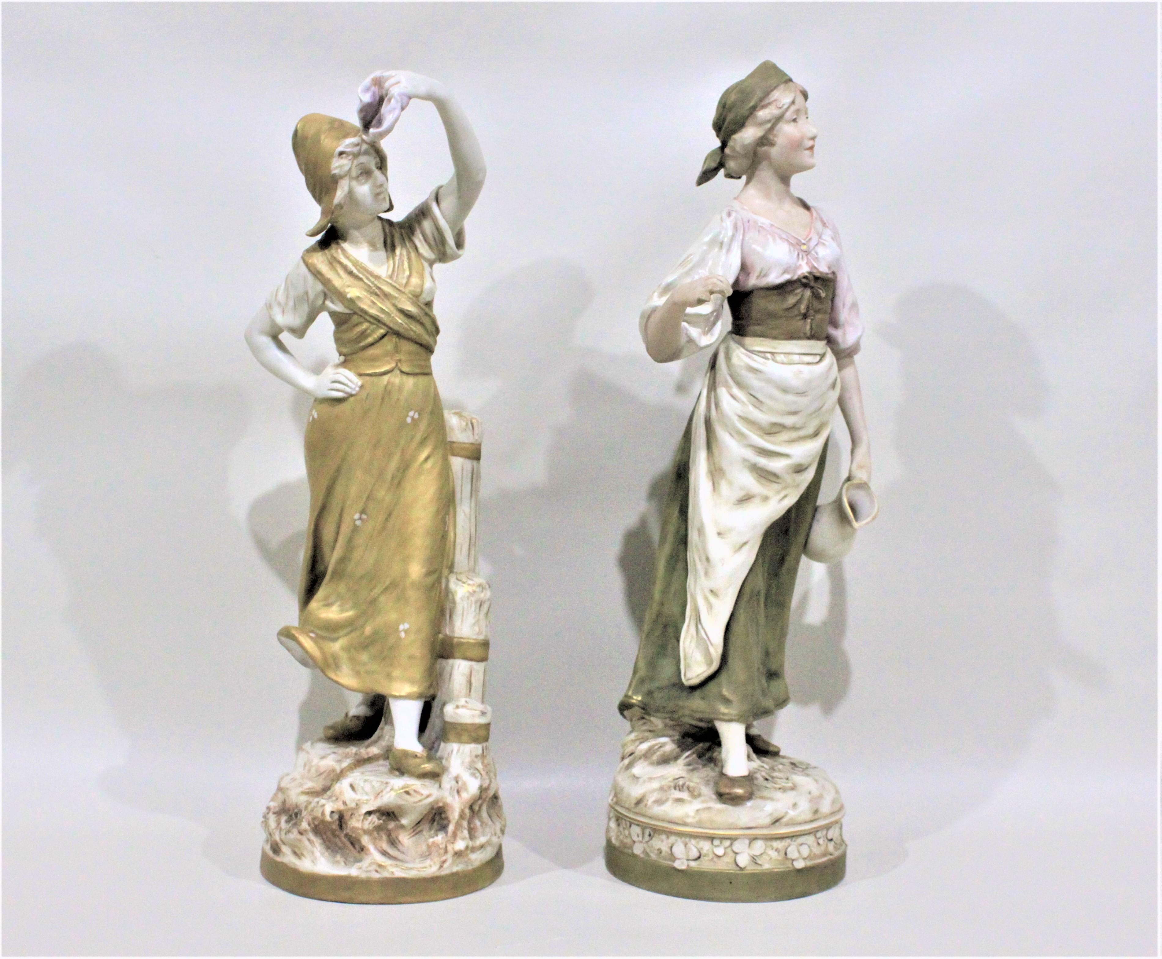 This pair of porcelain figurines were made by Royal Dux in approximately 1900 in the period and style of Art Nouveau. Both figurines are clearly marked with the early Royal Dux signature triangle and each stands approximately 17 inches in height.