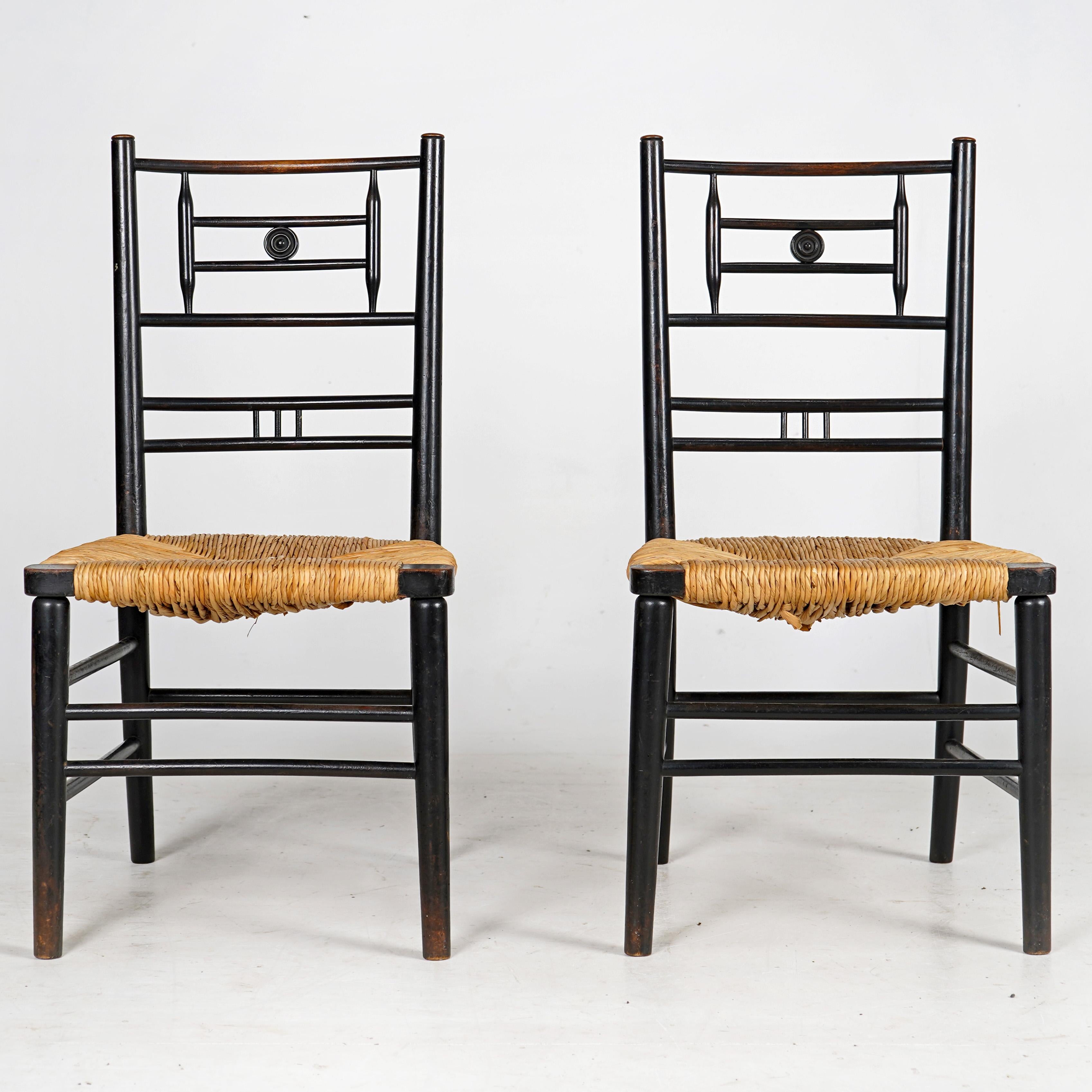 Pair of Arts and Crafts ebonised rush seat chairs. 
Early 20th century occasional chairs with newly rushed seats. 
Good useable condition, some remnants of wood worm, treated thoroughly. 

Dimensions
 
Height - 83cm
Width - 43cm
Depth - 38cm
Seat