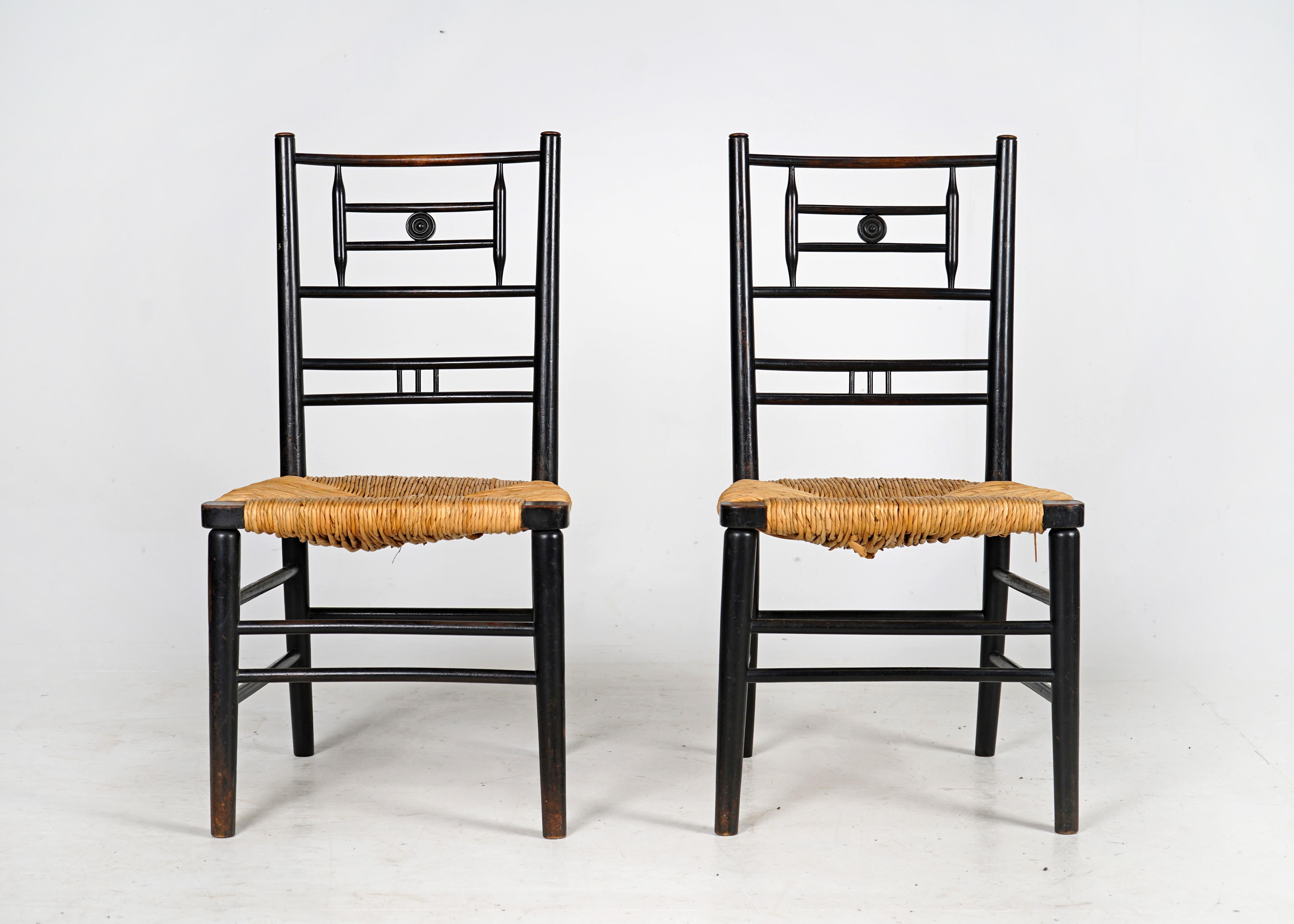 British Pair of Antique Arts and Crafts Ebonised Rush Seat Chairs