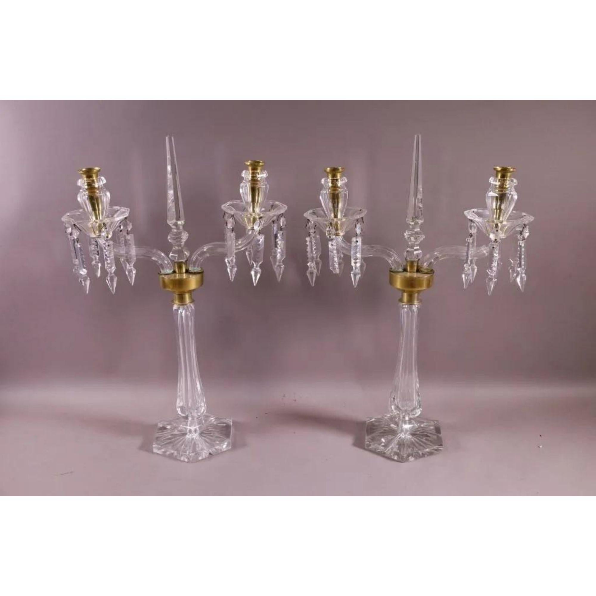 Pair of antique Austrian crystal candelabra. Each features a central obelisk mounted in bronze with two lights flanked by prism crystals.

Additional information: 
Materials: Crystal.
Color: Transparent.
Brand: Moser Glassworks.
Period: