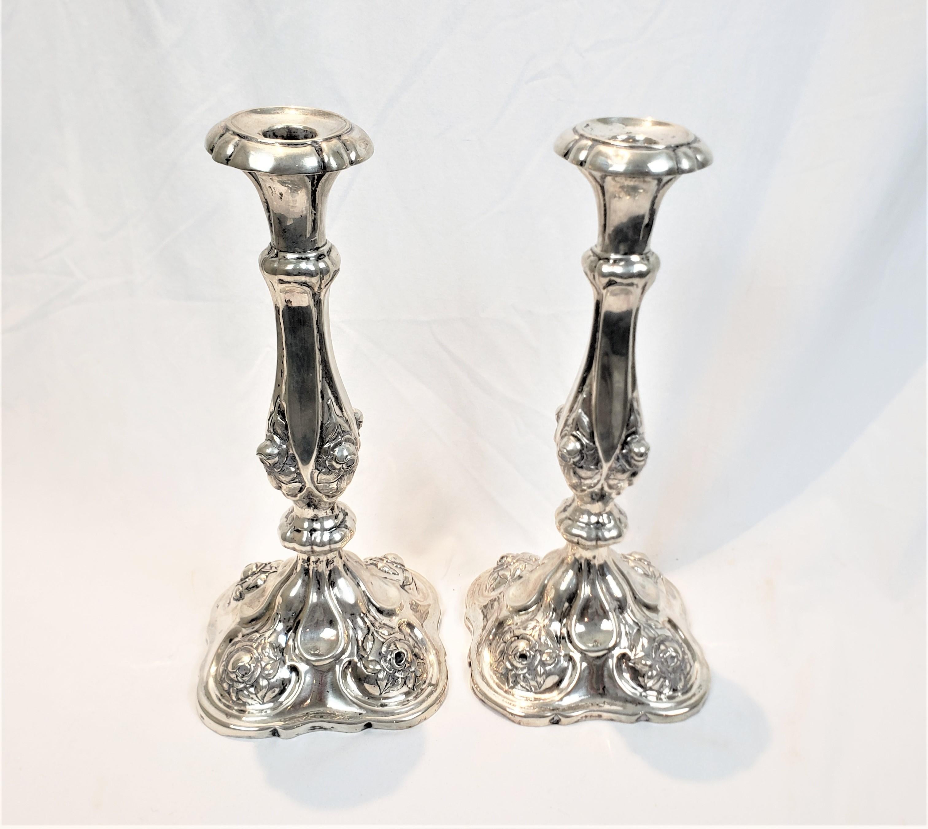 This pair of silver candlesticks are hallmarked by an unknown maker, and believed to have originated from the Austro-Hungarian Empire and date to approximately 1850, and done in the period style. These candlesticks are composed of .800 silver, if