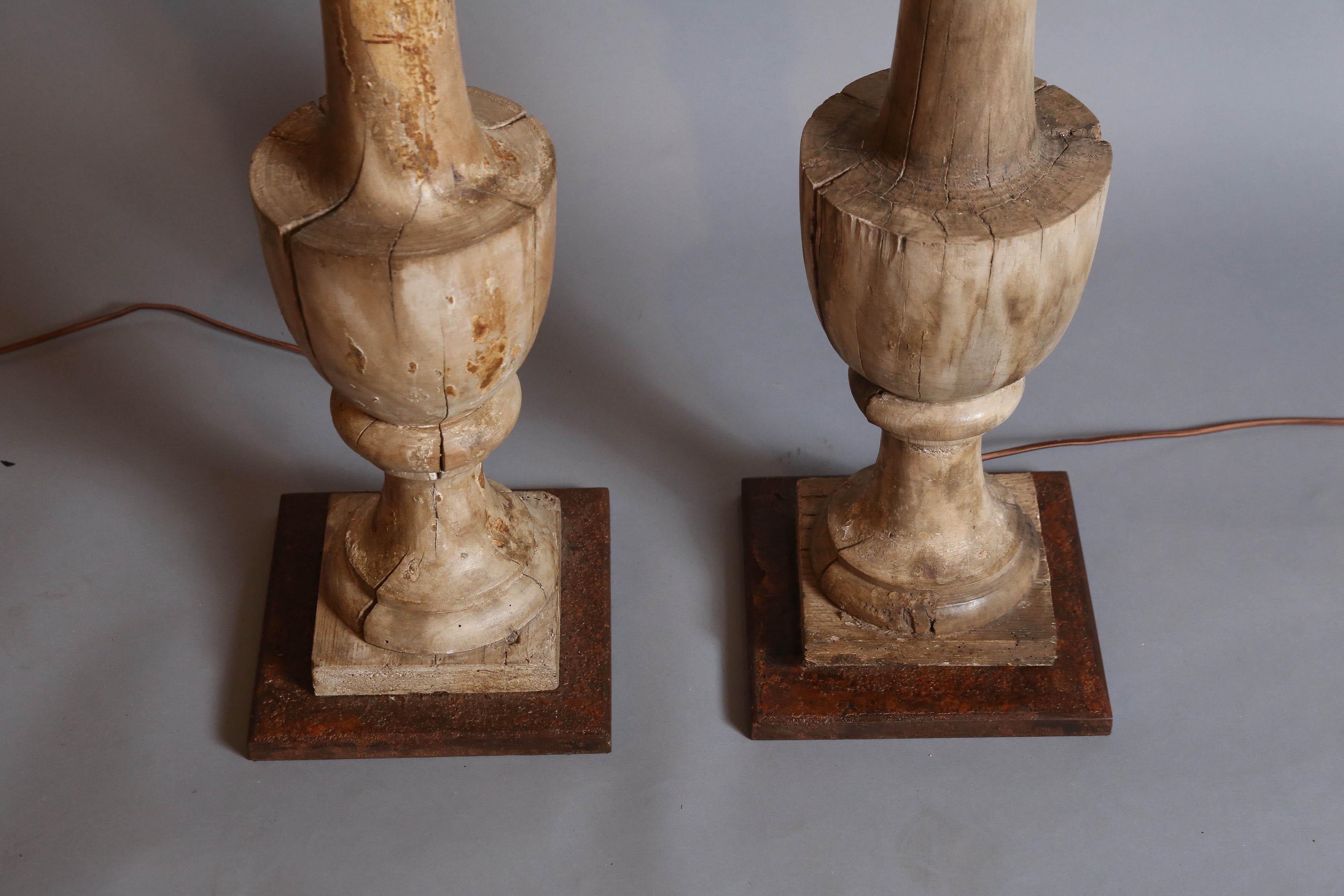 Pair of antique Balustrades with an urn shape were previously painted and stripped.
Lamps sit upon antiqued metal bases.
  