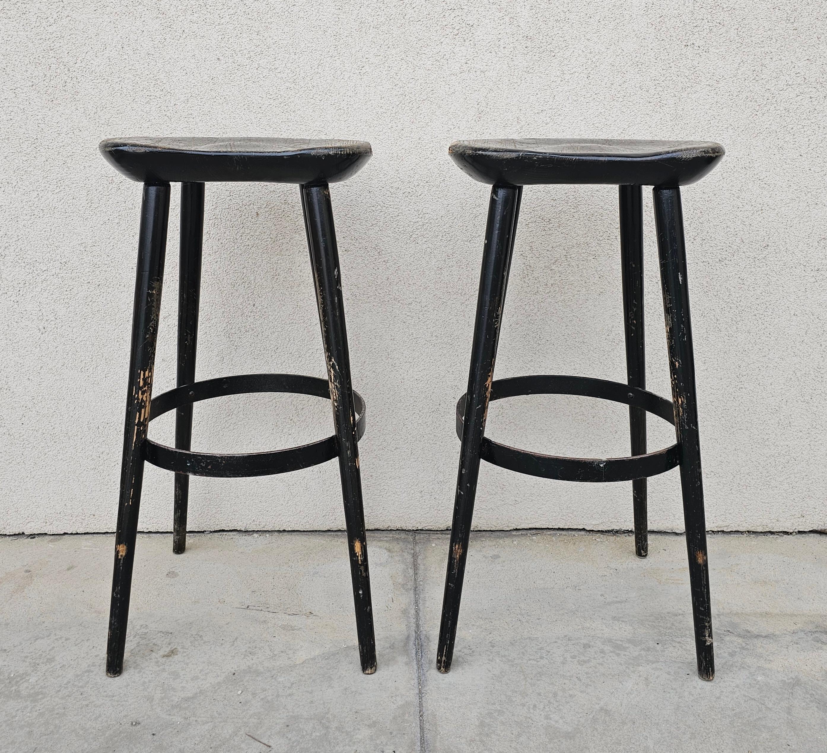 In this listing you will find a pair of antique bar stools with kidney shaped seats. Stools are made in solid oak, with the iron foot rest ring. Made in Austria cca. 1910s.

Stools are in fair antique condition with visible signs of time and use,