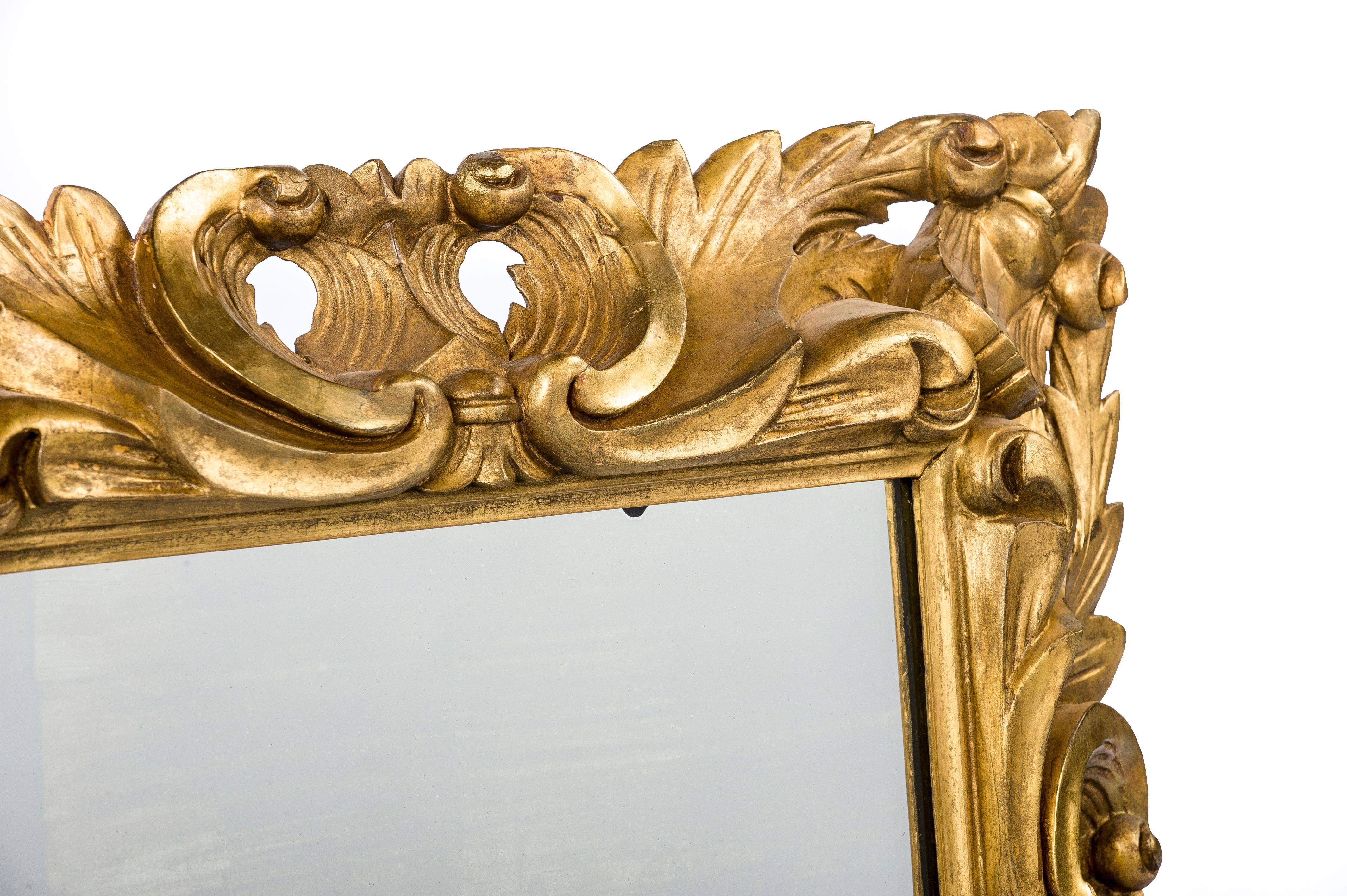 This beautiful pair of Italian Baroque mirrors were made in the first half of the 19th century.
The square frames are hand carved in lime wood and smoothened with gesso. The frame was adorned with typical Baroque design elements such as C-scrolls