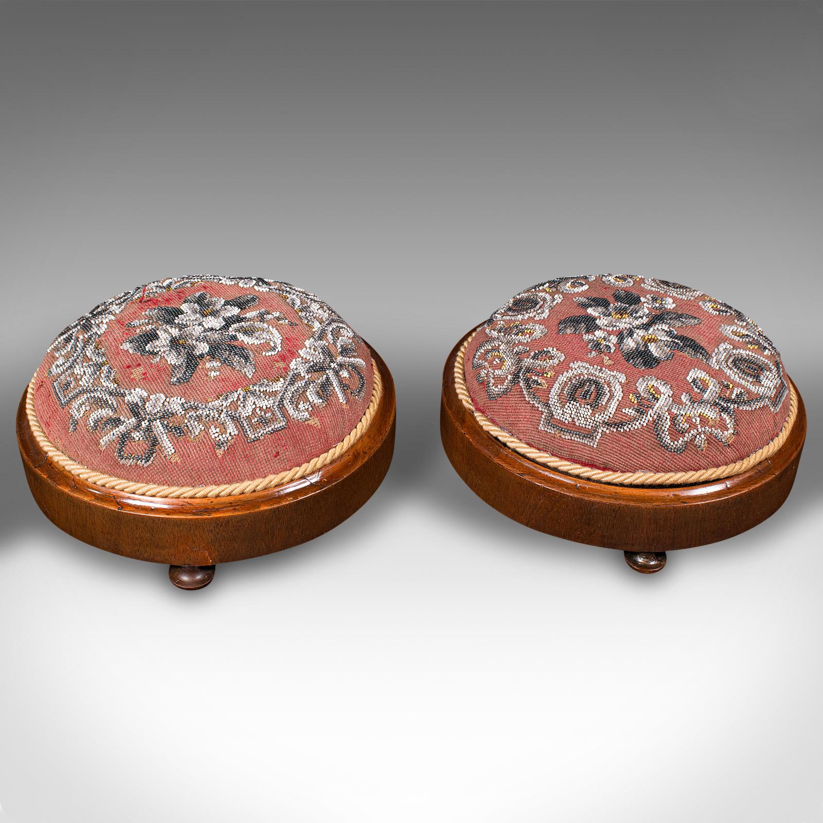 This is a pair of beadwork footstools. An English, mahogany decorative rest, dating to the early Victorian period, circa 1860.

Quality Victorian stools, with appealing decor
Displaying a desirable aged patina with minimal loss
Select stocks present