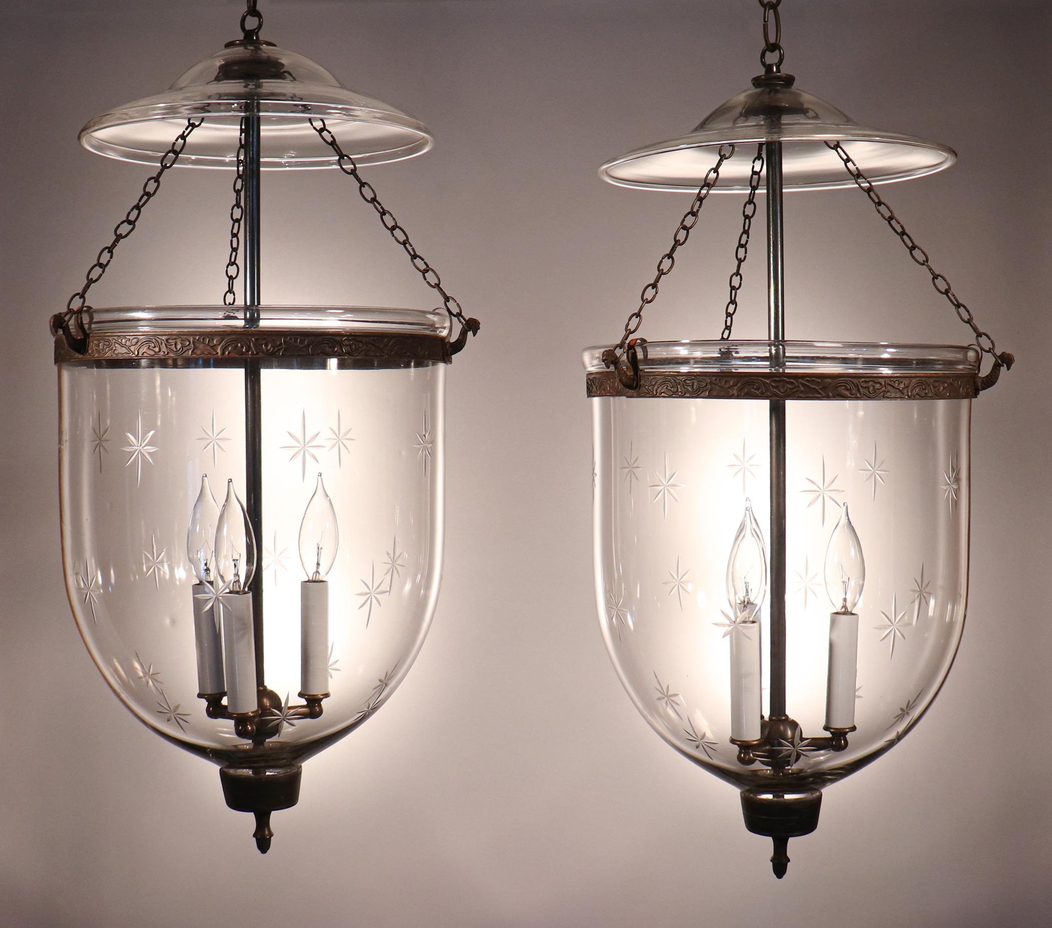 An exquisite pair of antique English bell jar lanterns with an etched star motif, circa 1880. These well-matched lanterns are of very good quality, with desirable swirls and air bubbles in the hand blown glass. They have been newly electrified with
