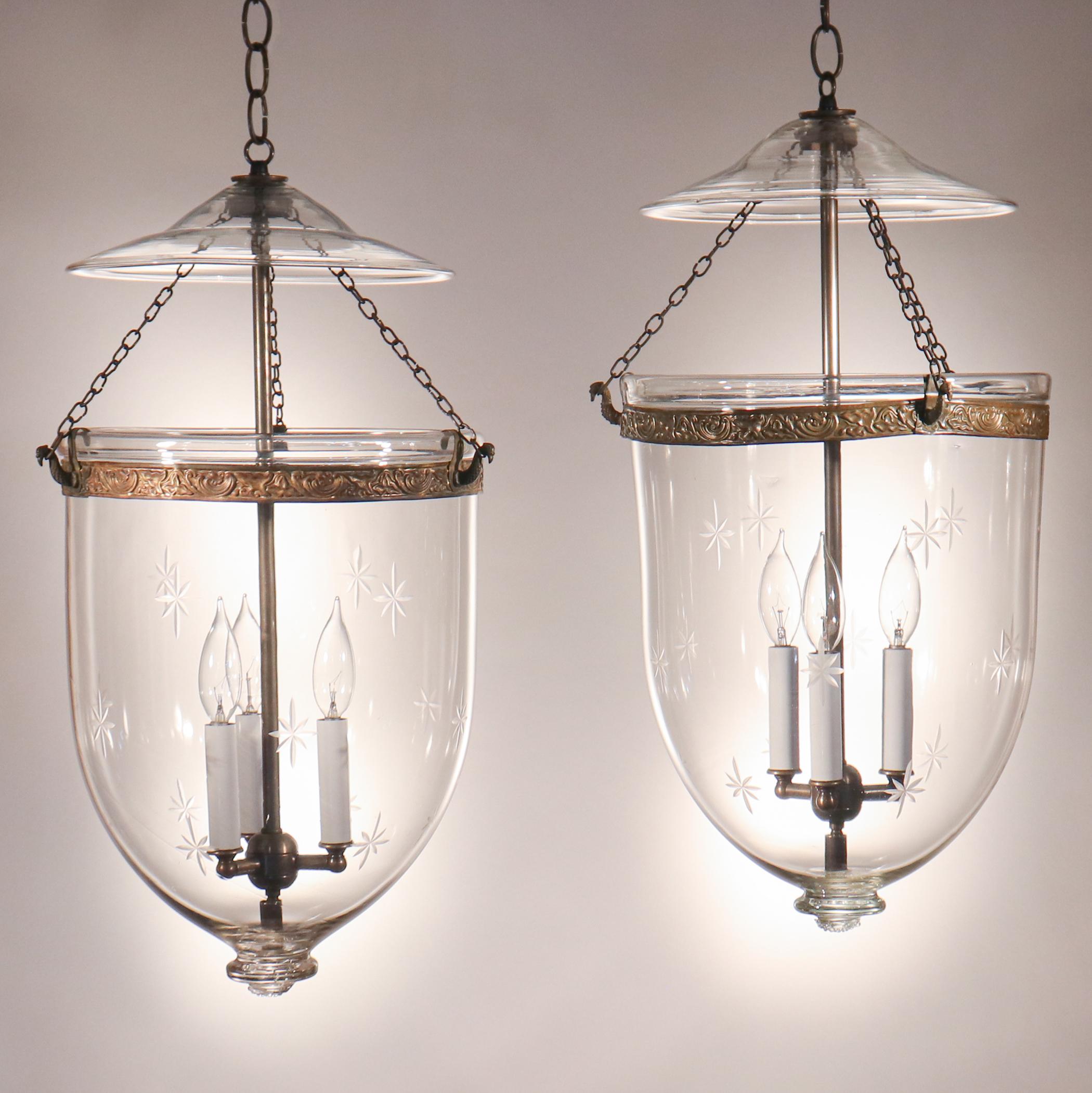An exquisite pair of English bell jar lanterns, circa 1870, with an etched star motif and all-original brass fittings. These well-matched pendants feature excellent quality hand blown glass, replete with desirable swirls and air bubbles. The