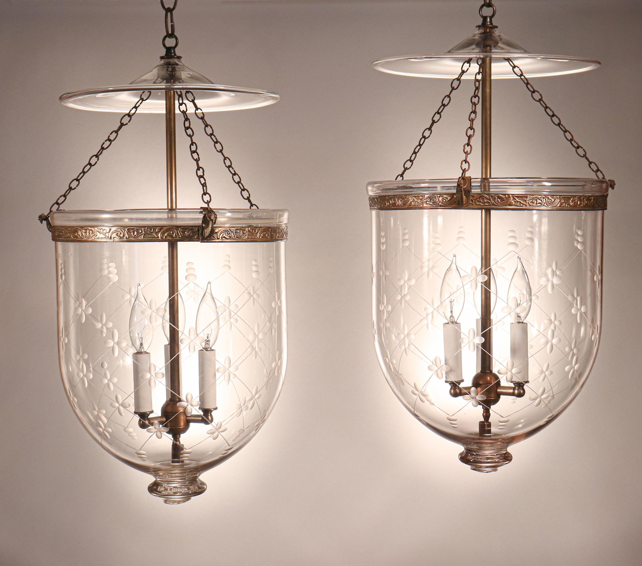 An exquisite pair of antique bell jar lanterns with an etched trellis motif. These circa 1890 lanterns, manufactured by S&C Bishop England, feature excellent quality hand blown glass and bear the Bishop name on the pontils, as well as on the jar of