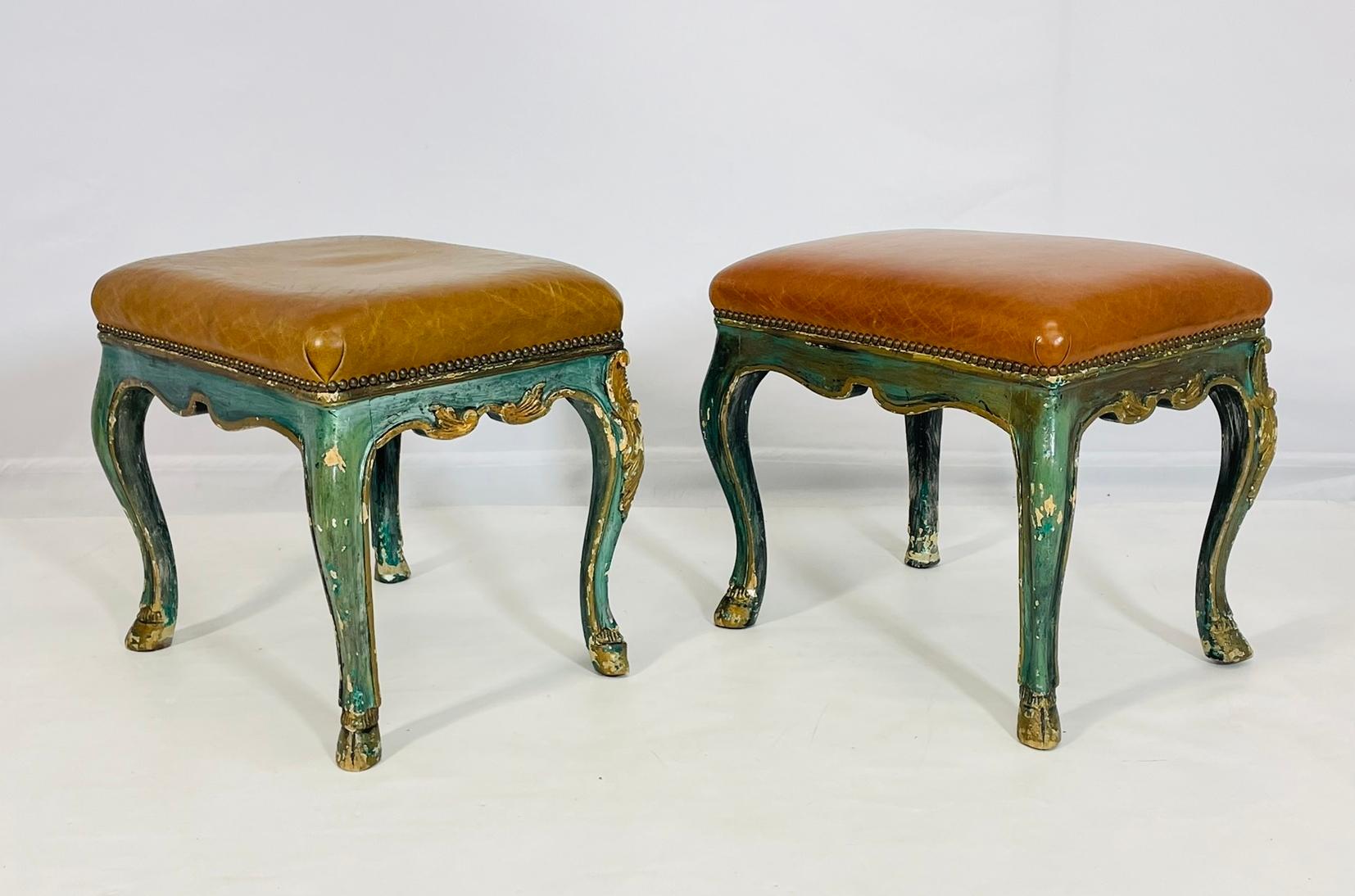 Enhance the elegance of your living space with this exquisite Pair of Antique Benches from France, dating back to the 1900's. Featuring luxurious leather upholstery in a rich brown hue, these benches are supported by ornate giltwood frames that