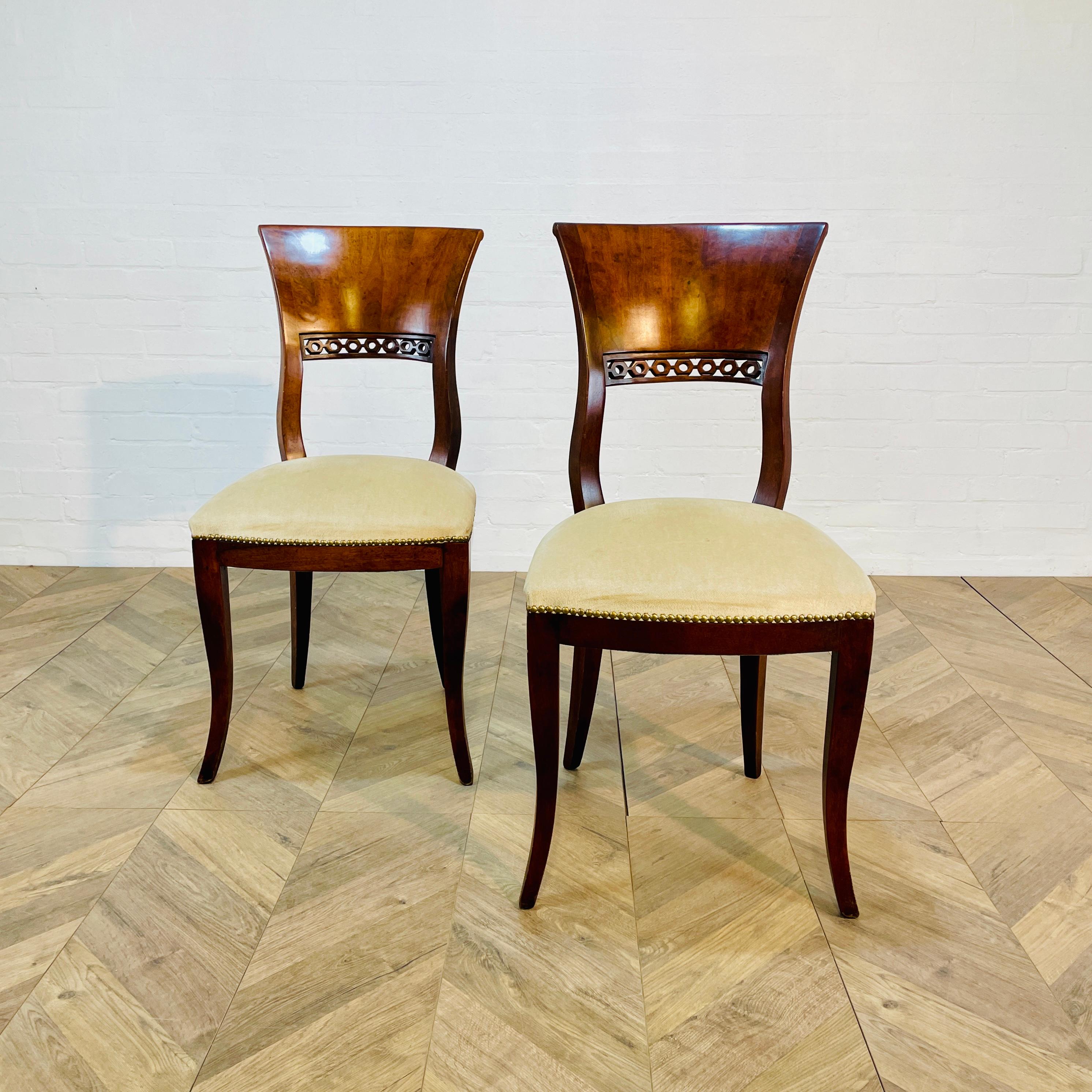 A Beautiful Pair of European Antique Biedermeier Mahogany Side Chairs, circa 1830s. 

The chairs are in wonderful condition with lovely details. The seats are upholstered in beige fabric (potentially professionally upholstered at a later