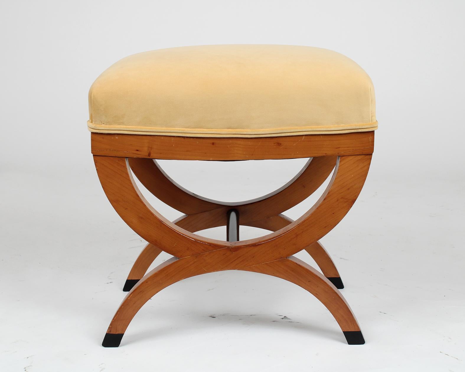 This beautiful pair of antique Biedermeier style stools are made out of maple wood and in good condition. The stools feature an X-design pedestal legs with a maple and ebonized color finish, and have been newly waxed and polished giving it a nice